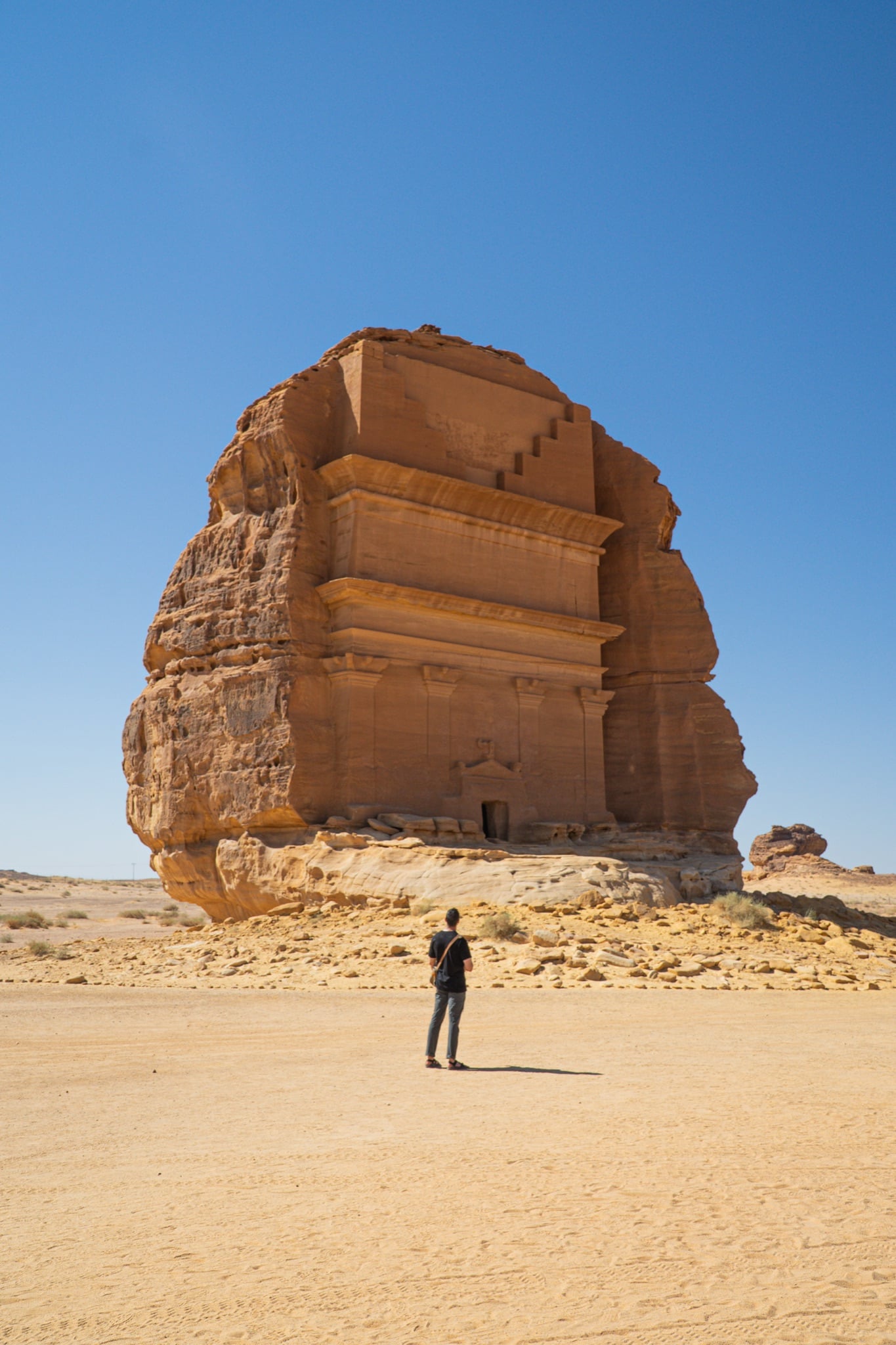 Kendrick standing before the Tomb of Lihyan, Hegra, Saudi Arabia