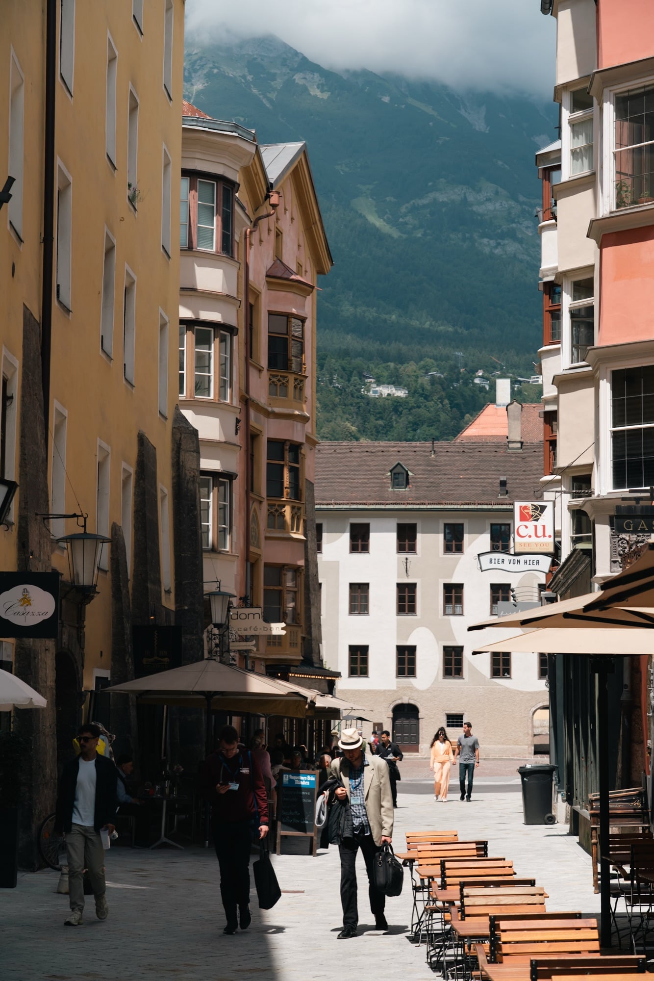 A narrow old-town lane opening to the mountains, Innsbruck