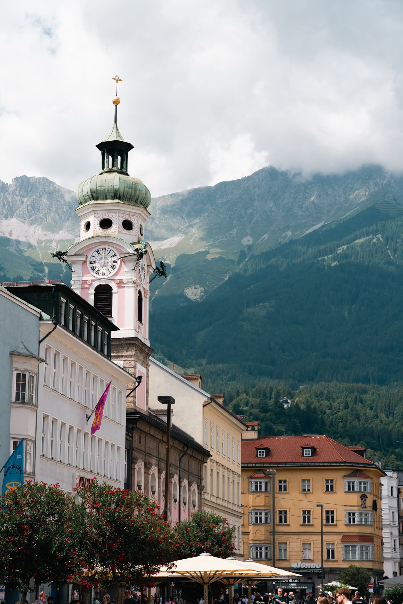 A green-domed church tower against the mountains, Innsbruck