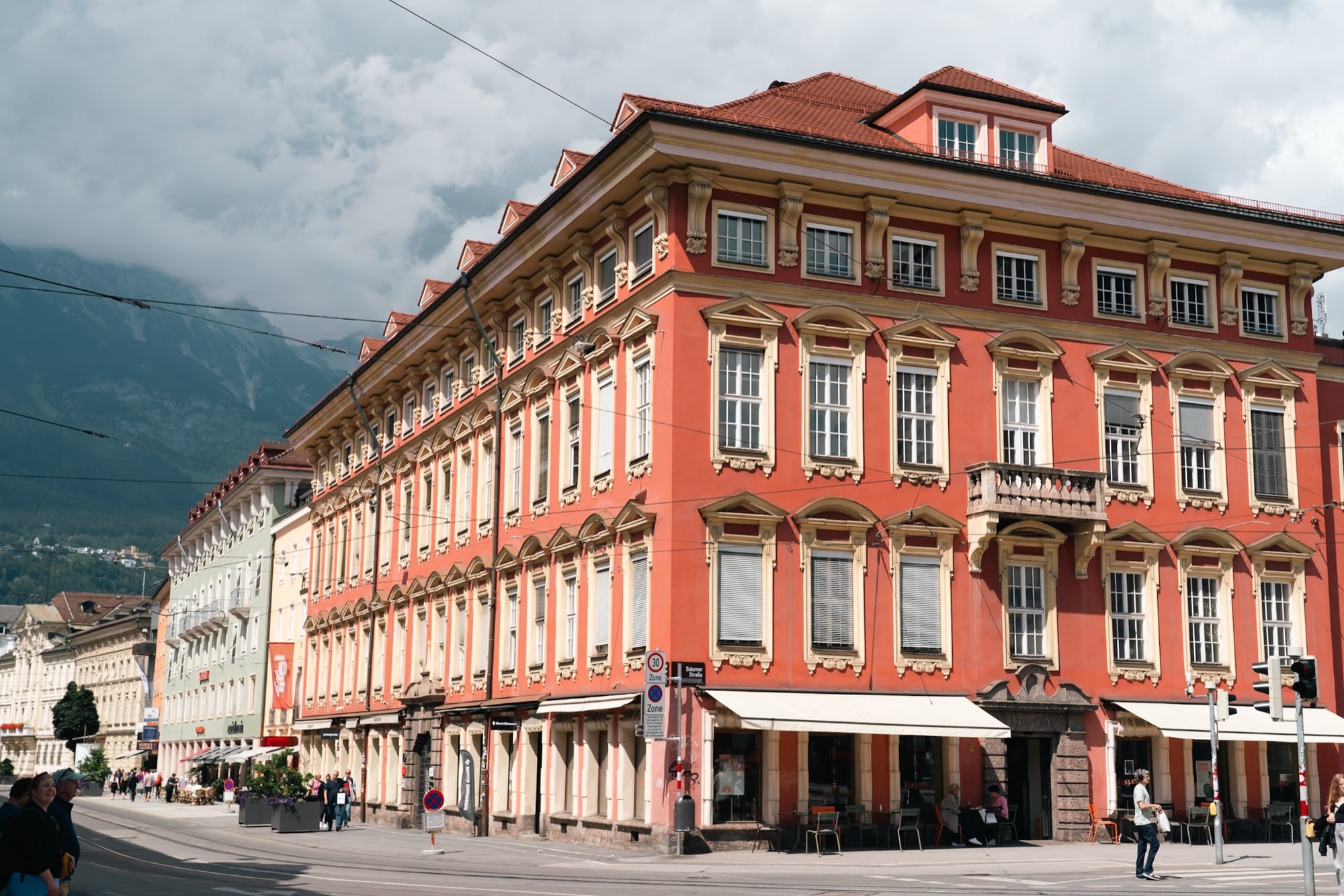 A grand salmon-red Baroque palace along the street, Innsbruck