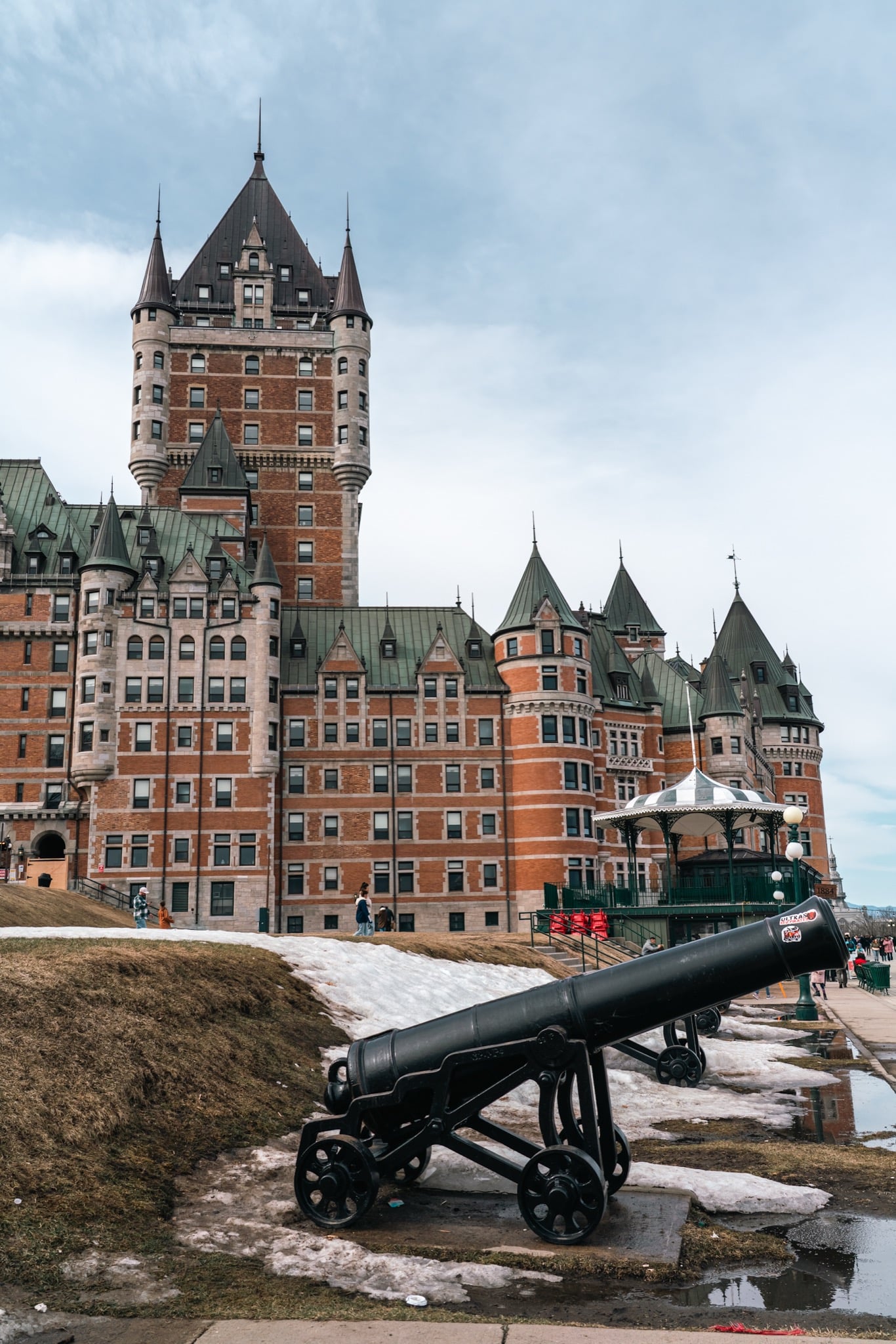 The Château Frontenac beyond an old iron cannon on the terrace