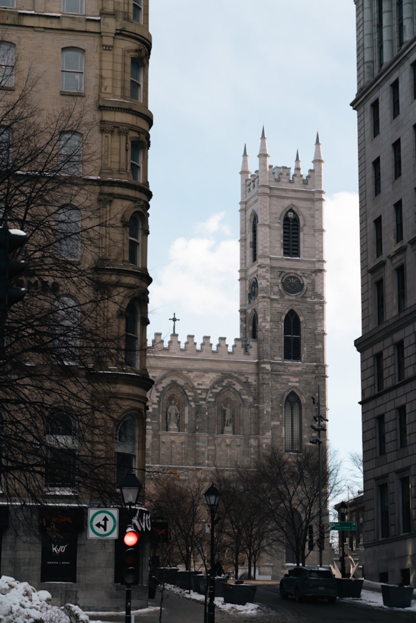 The twin towers of the Notre-Dame Basilica glimpsed down a street