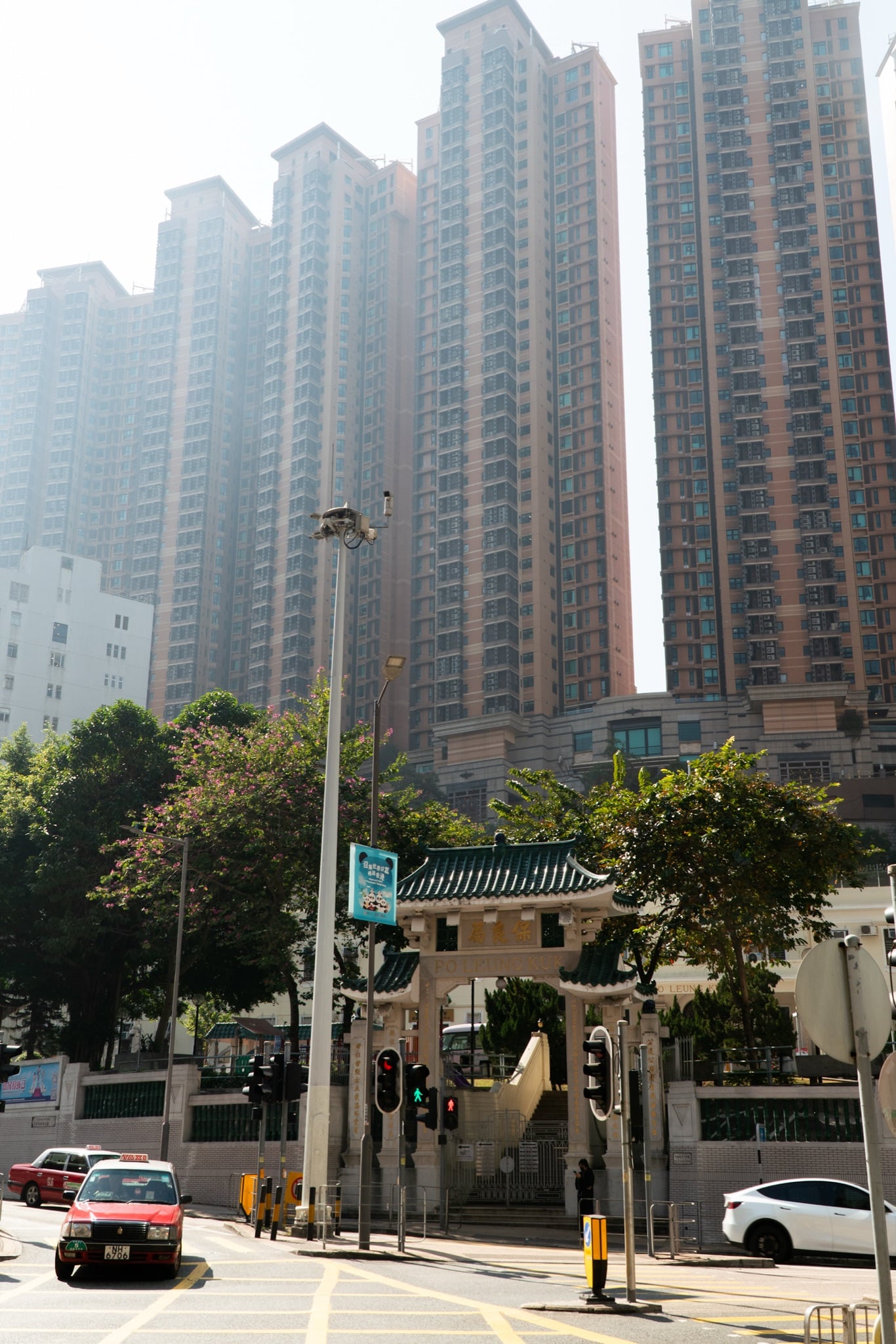 Residential towers rising above a traditional gateway in Central, Hong Kong
