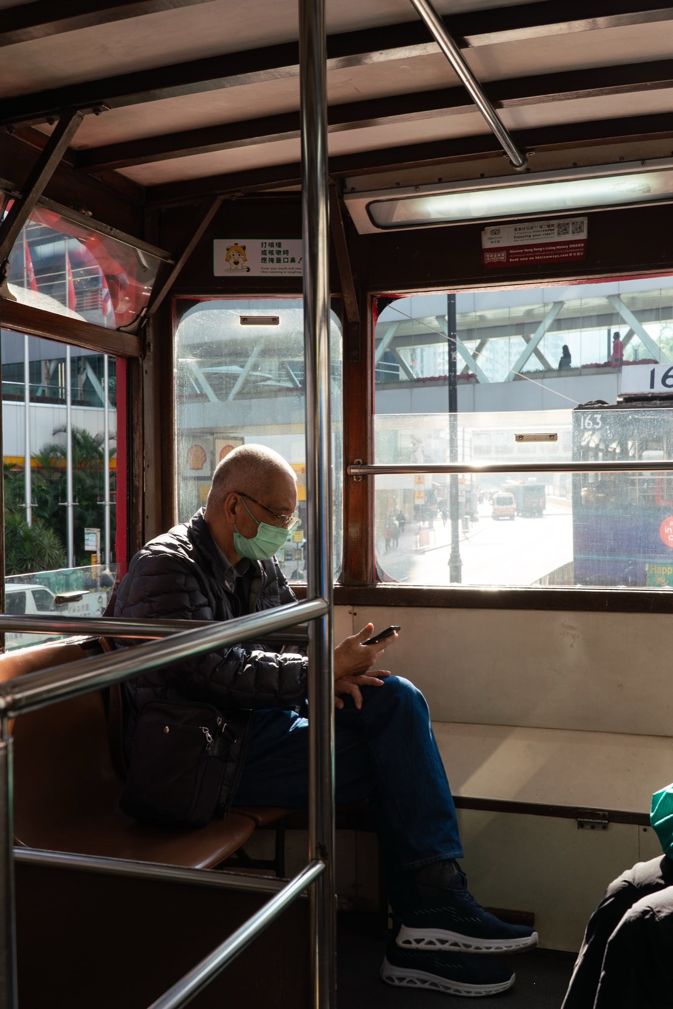 A double-decker bus passing beneath the Quarry Bay towers, Hong Kong