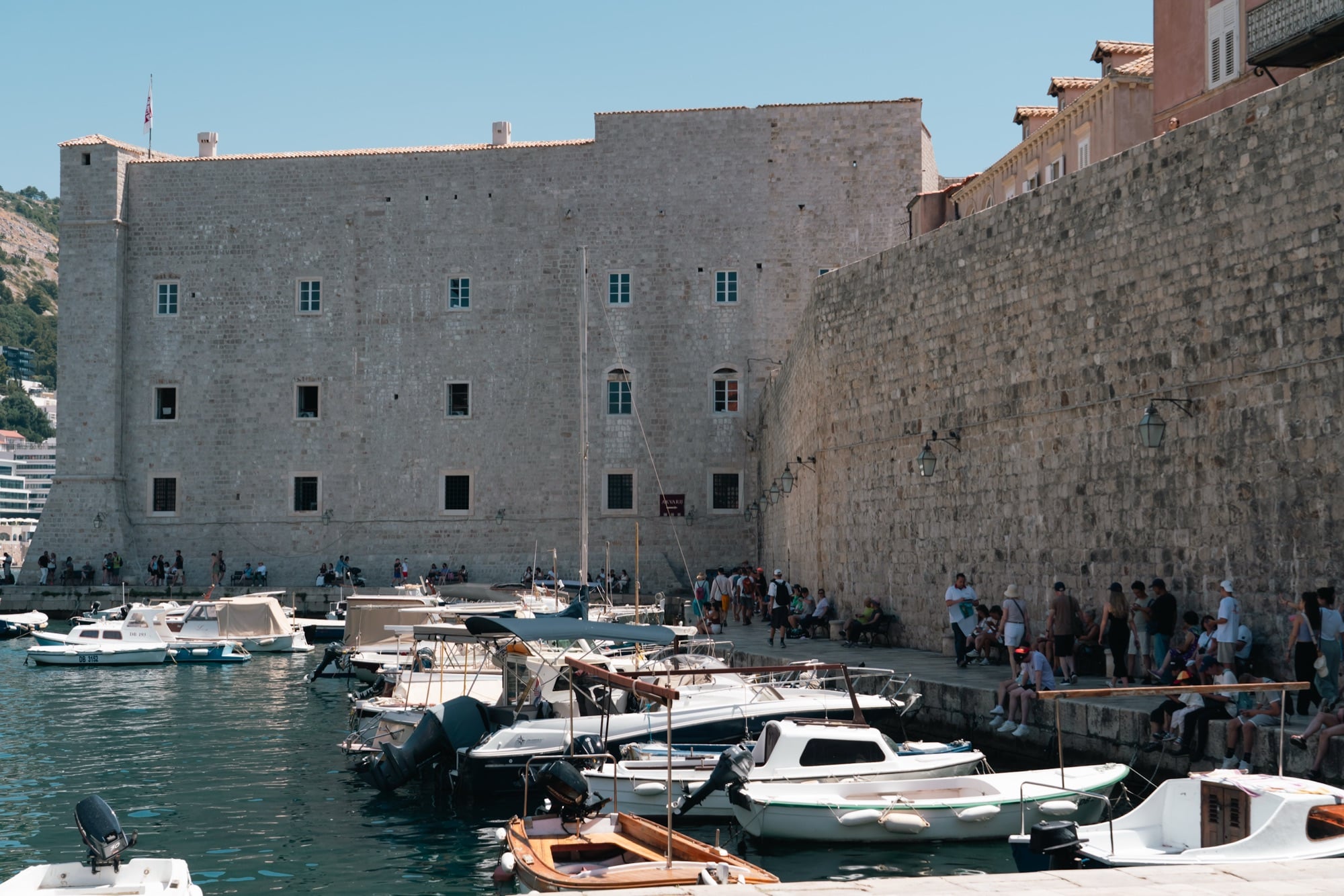 The Revelin fortress and moored boats along the Old Port walls, Dubrovnik