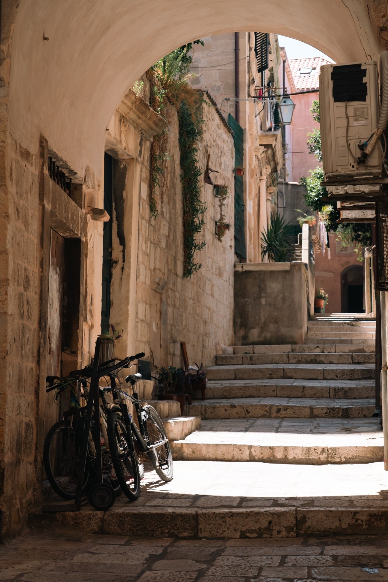 A bicycle leaning in a shaded Old Town side street, Dubrovnik