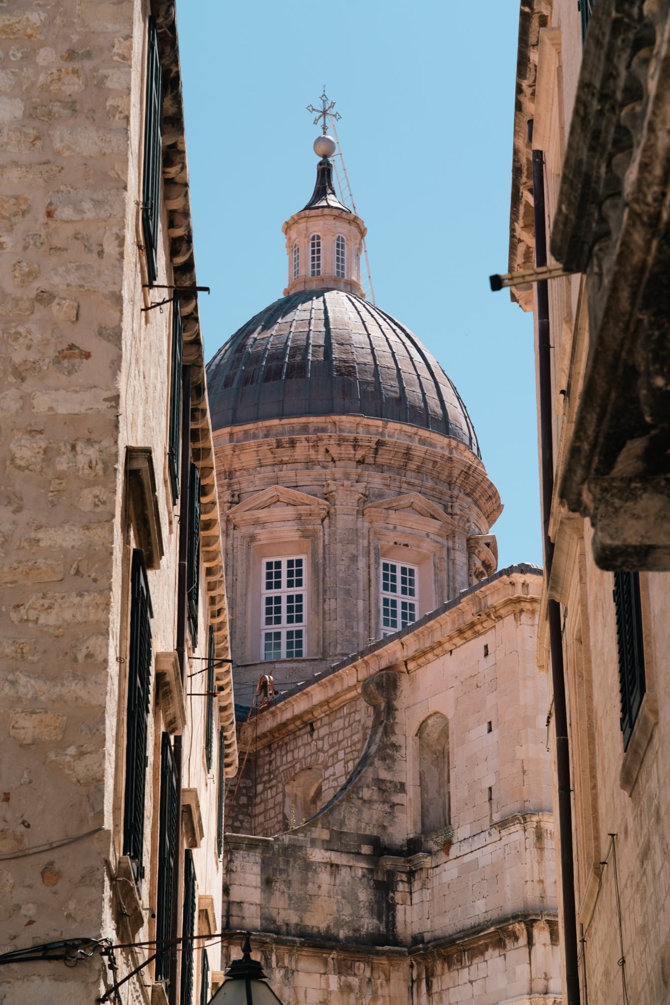 The Cathedral dome framed at the end of a narrow Old Town street, Dubrovnik