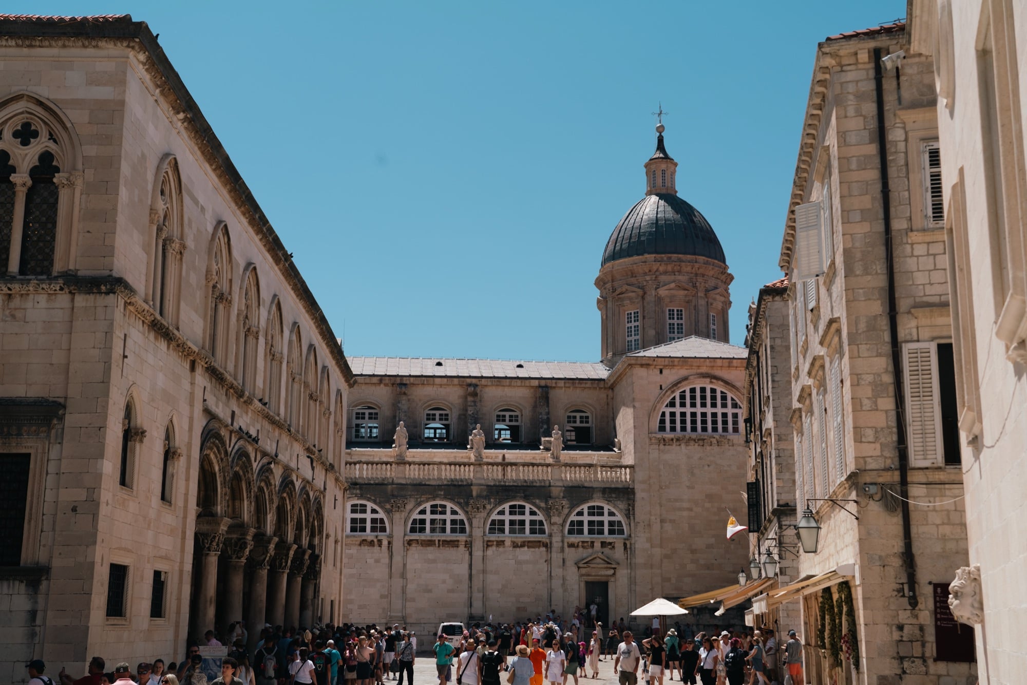 The Stradun thronged with visitors, the Cathedral dome and Sponza Palace beyond, Dubrovnik
