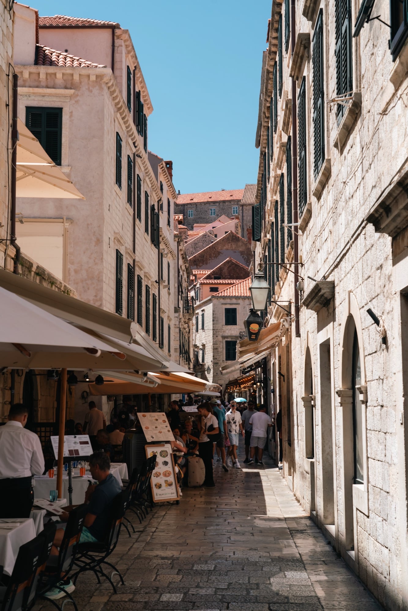 Market stalls shaded by awnings along a narrow Old Town lane, Dubrovnik