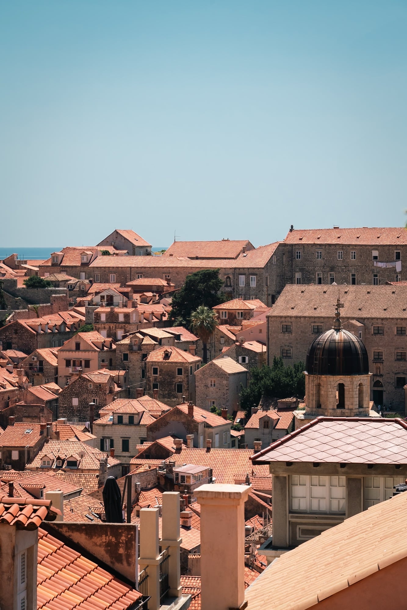 Red-tiled roofs of the Old Town running down to the city walls and the sea, Dubrovnik