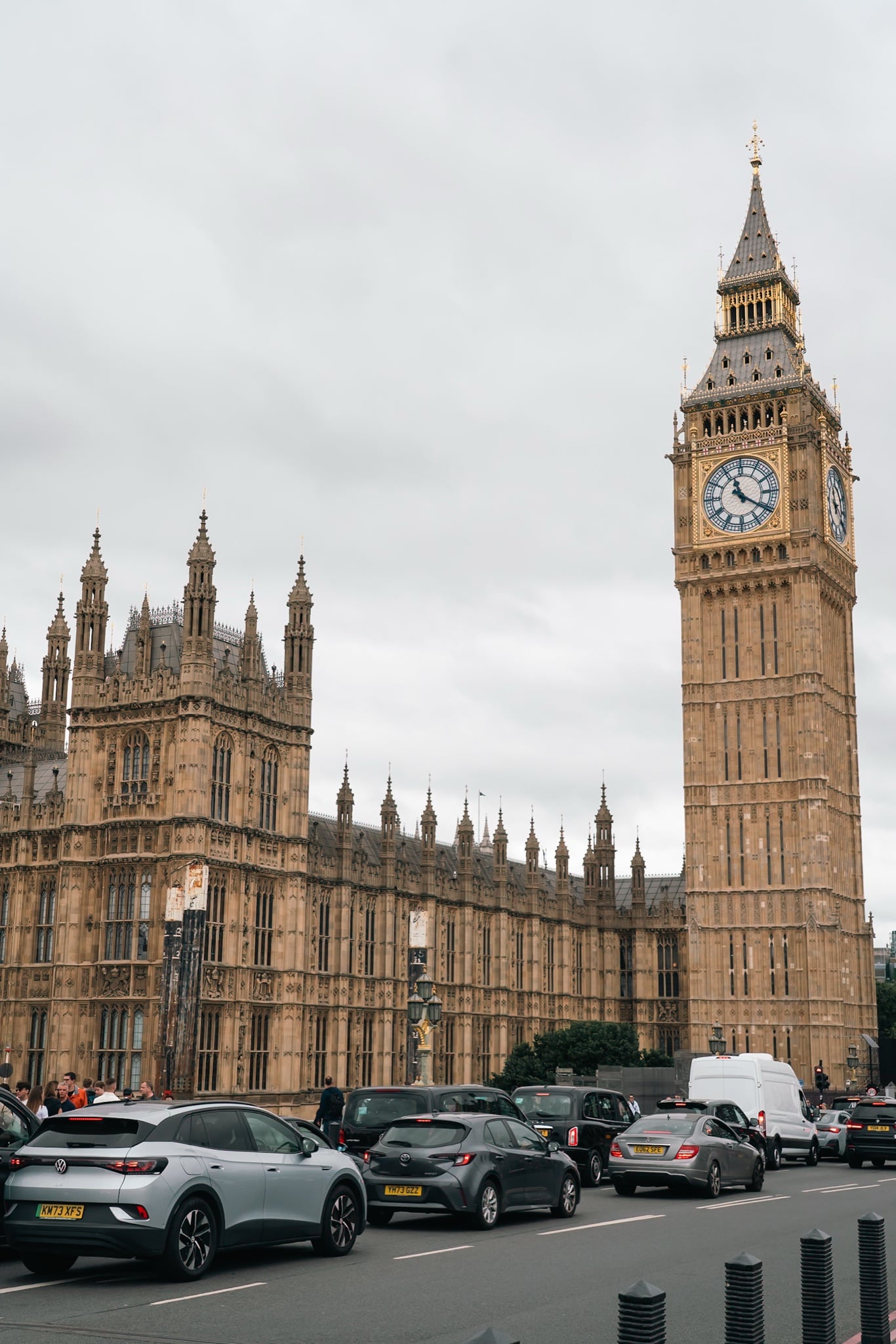 Big Ben and the Houses of Parliament rising above the traffic on Westminster's roadside