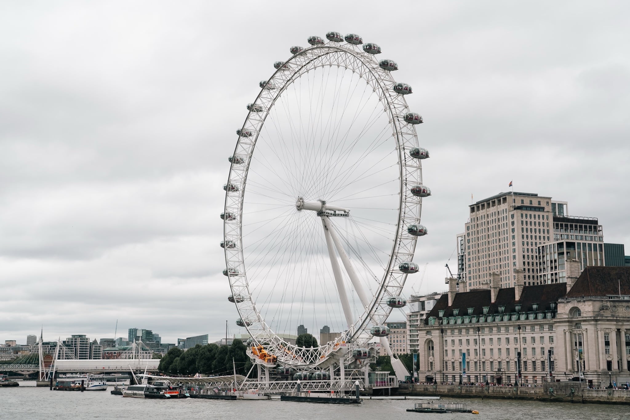 The full London Eye wheel across the Thames beside County Hall