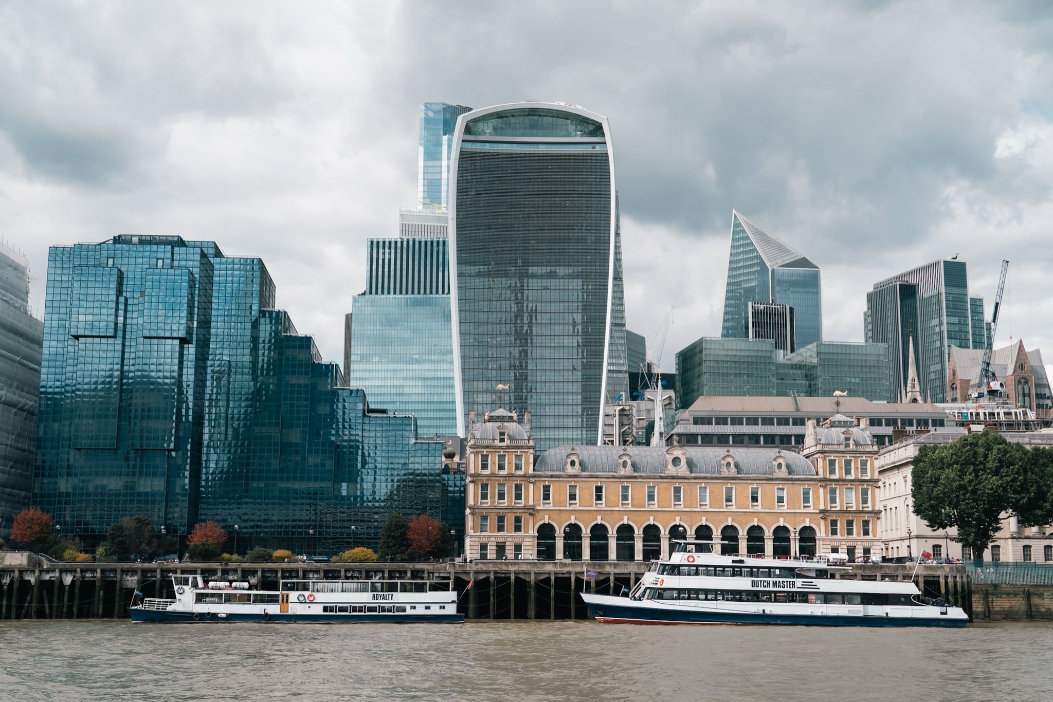 The City of London skyline with the Walkie-Talkie and Scalpel towers above moored river boats