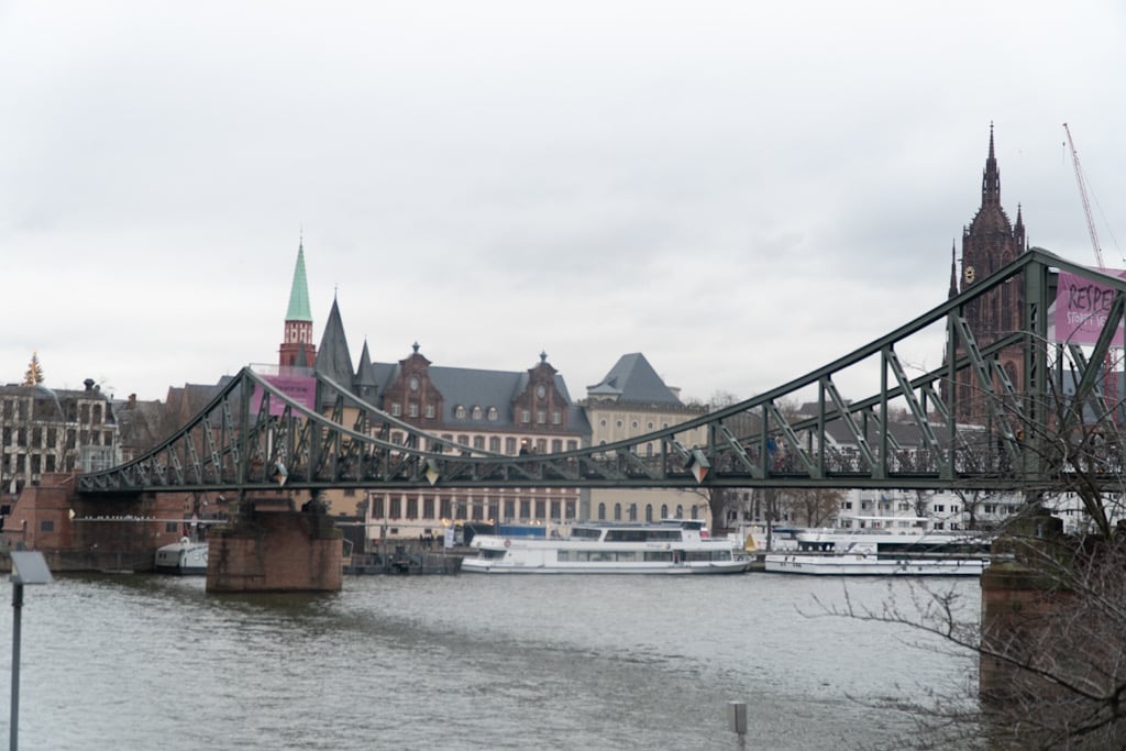 The Eiserner Steg footbridge over the River Main with Frankfurt Cathedral rising behind