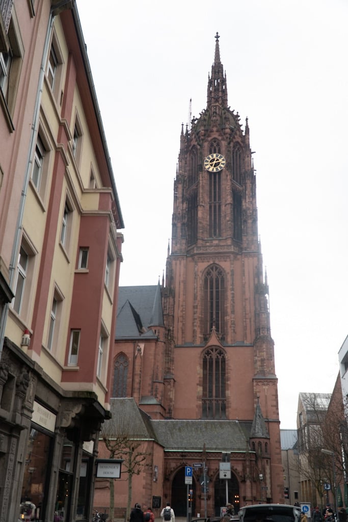 The Gothic tower of Frankfurt Cathedral with its golden clock