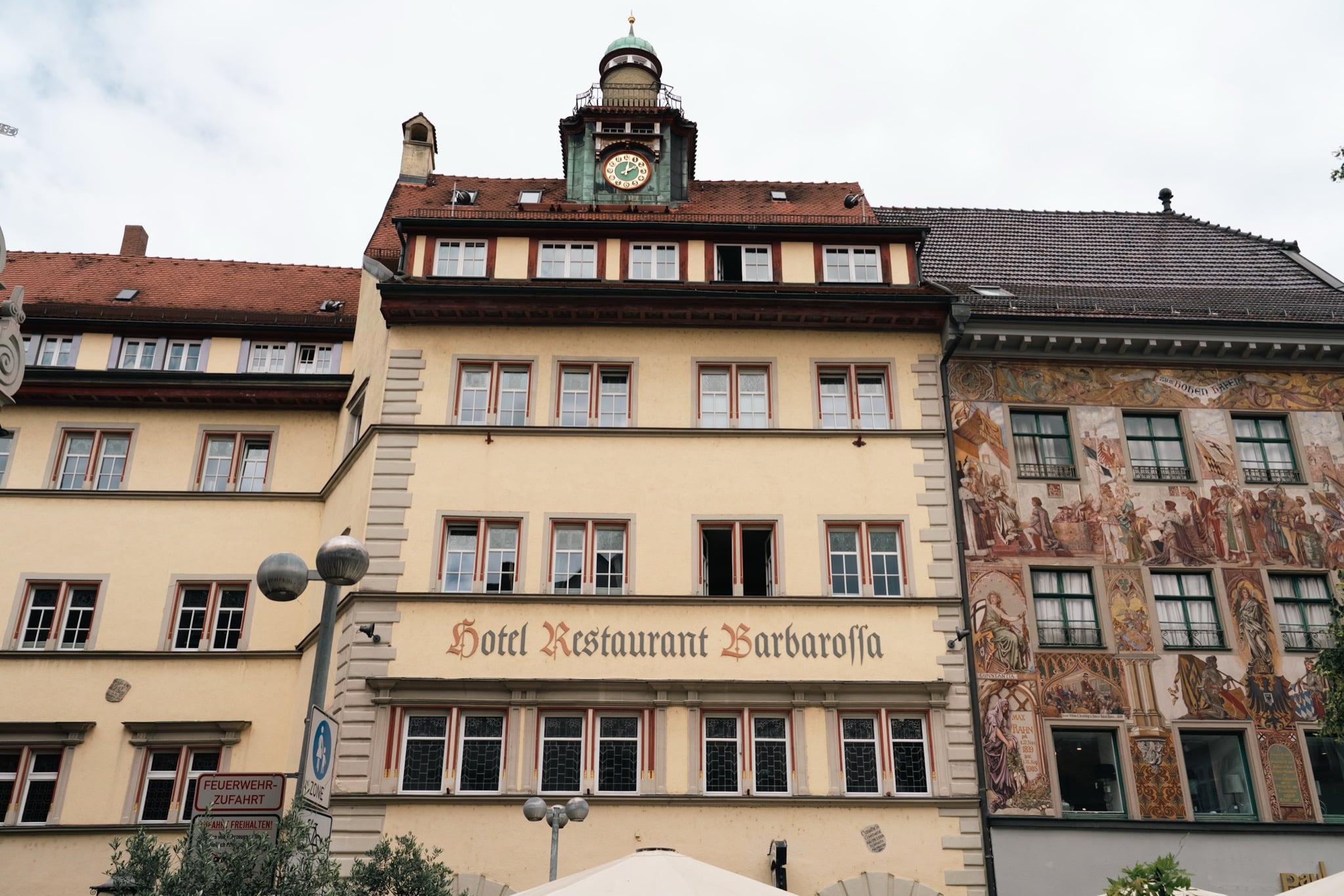 The painted facade and clock turret of the Hotel Barbarossa in old Konstanz