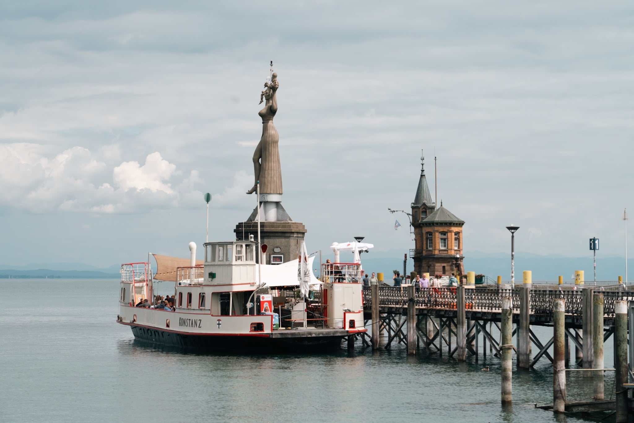 The ferry Konstanz moored at the harbour beside the Imperia statue and the old harbourmaster's tower