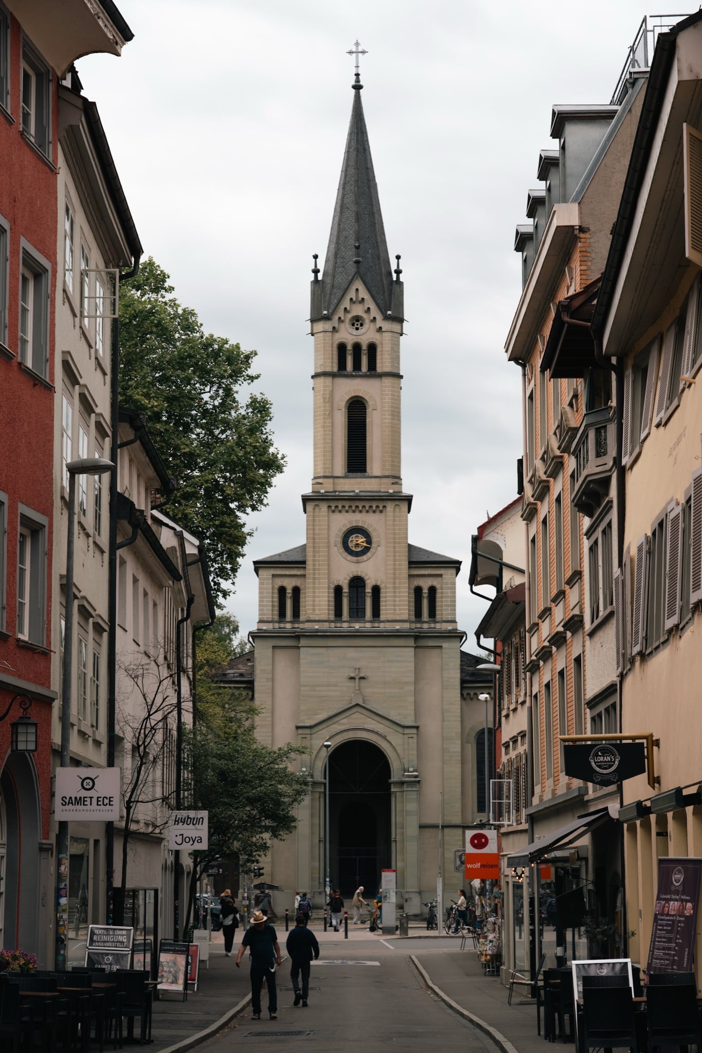 A neo-Romanesque church tower closing the view down an old-town street in Konstanz