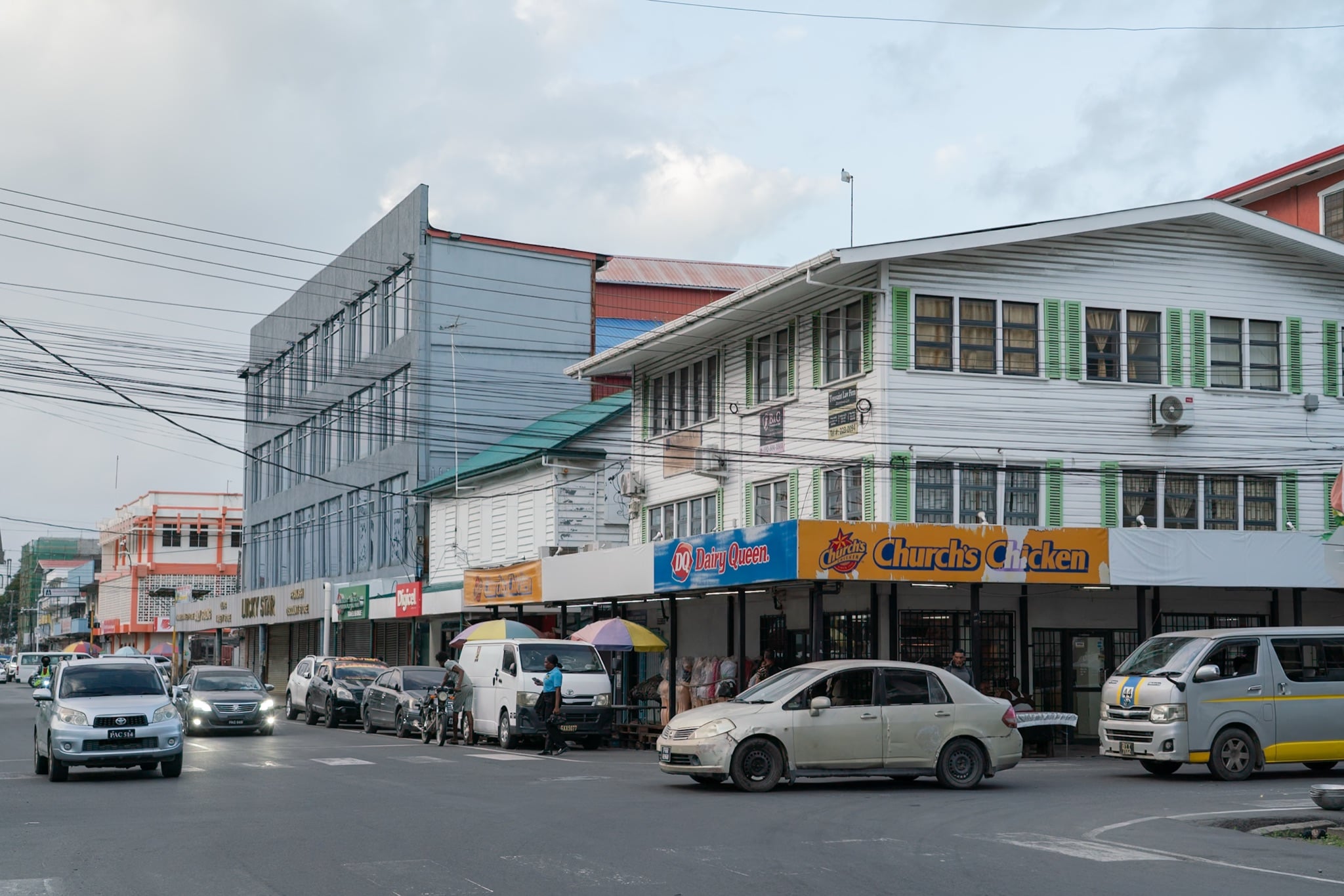 A commercial street corner with parked cars in Georgetown