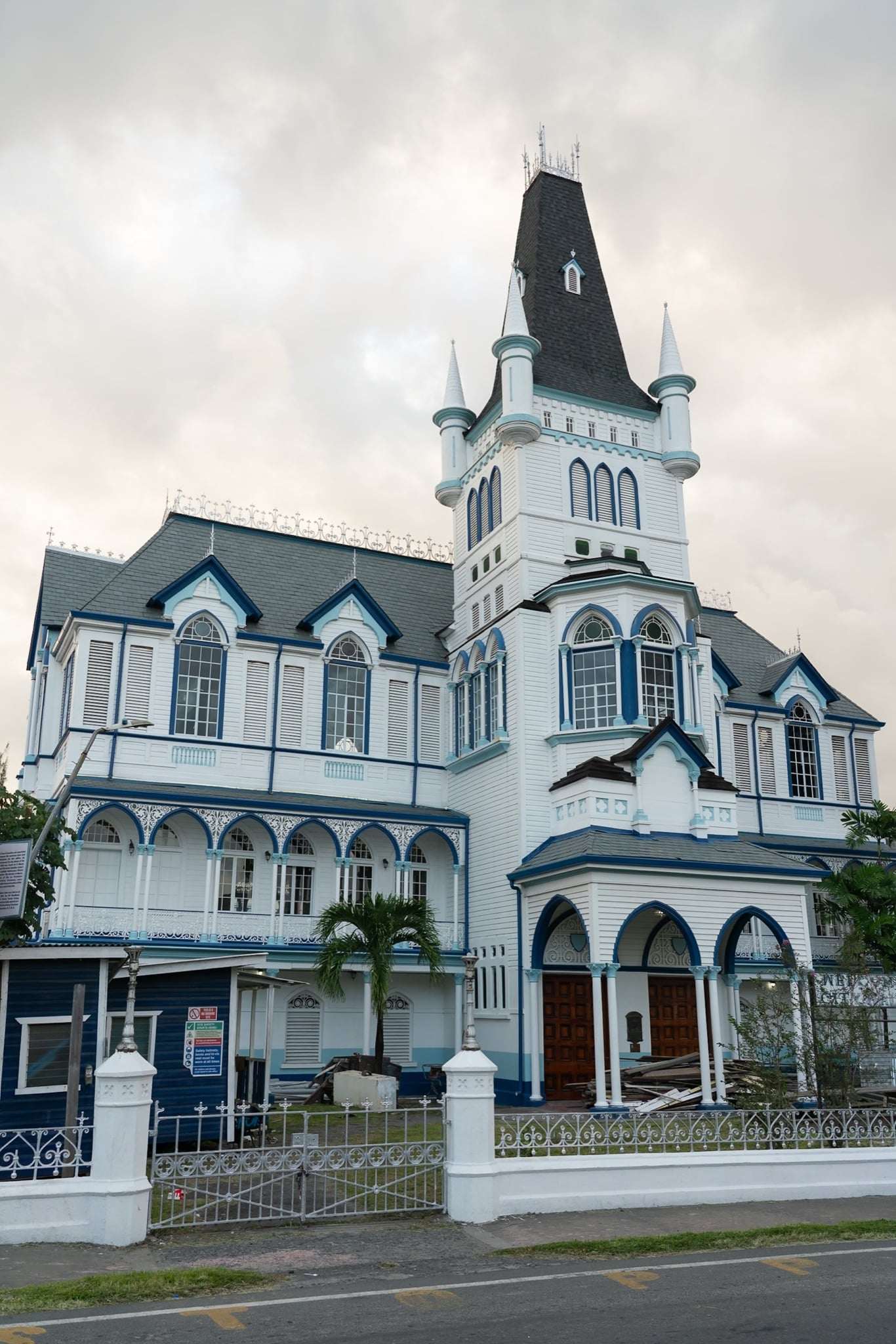 A white-and-blue colonial building crowned by a slender spire