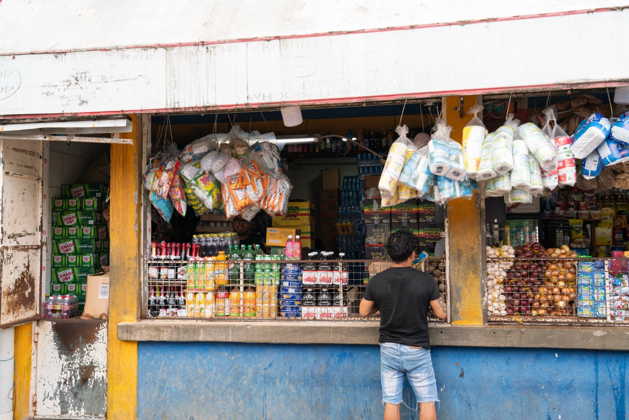 A stall stocked with drinks and provisions at the edge of Stabroek Market