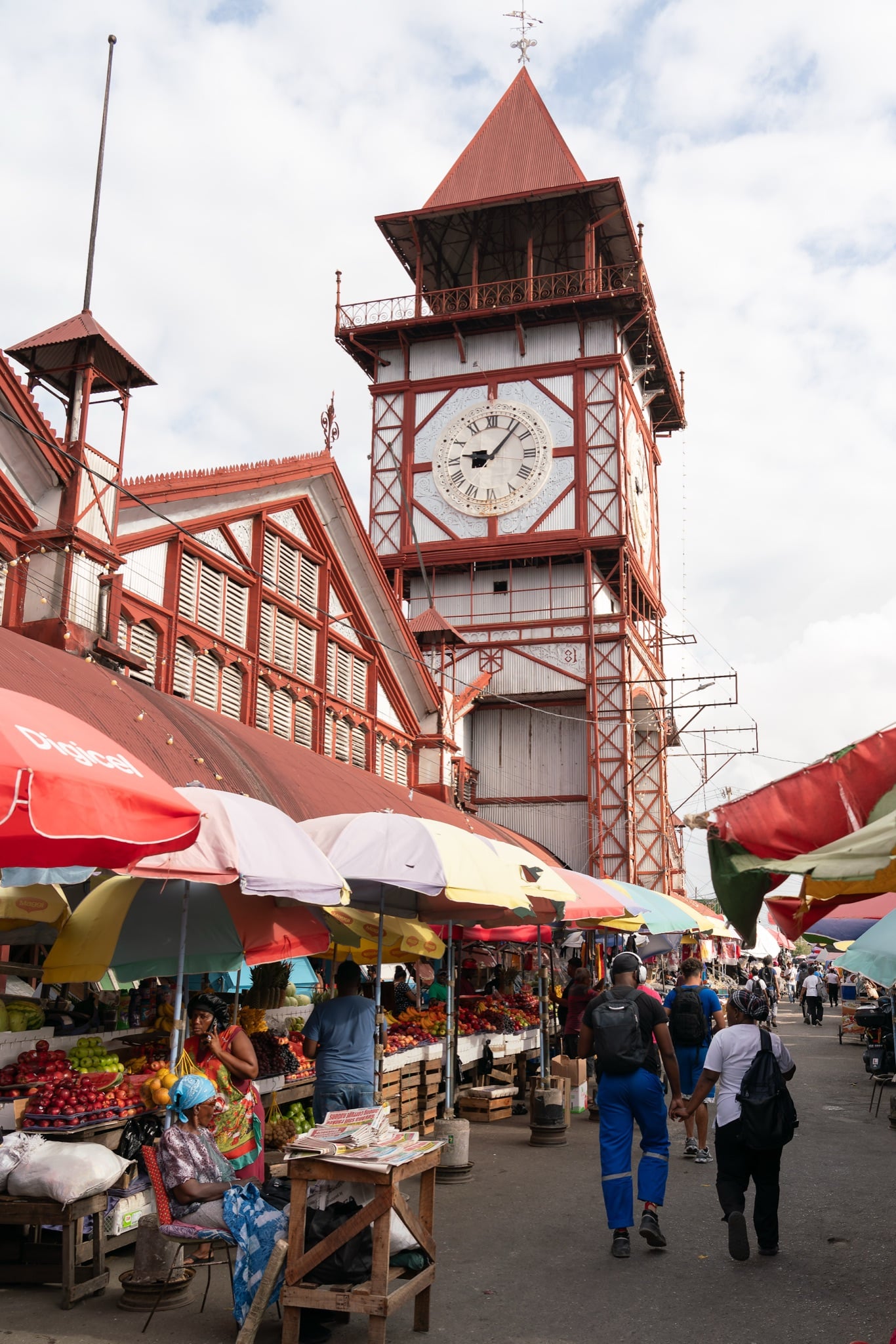The Stabroek Market clock tower above rows of colorful vendor umbrellas
