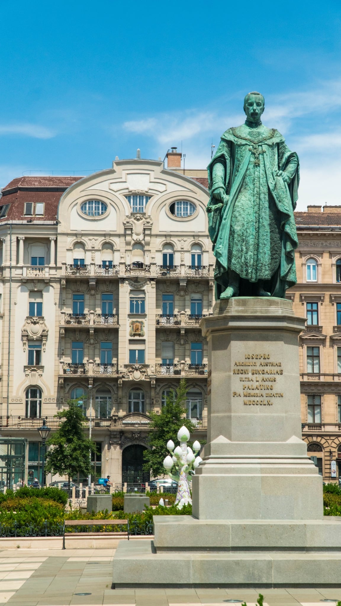 The bronze statue of Archduke Joseph before an Art Nouveau facade