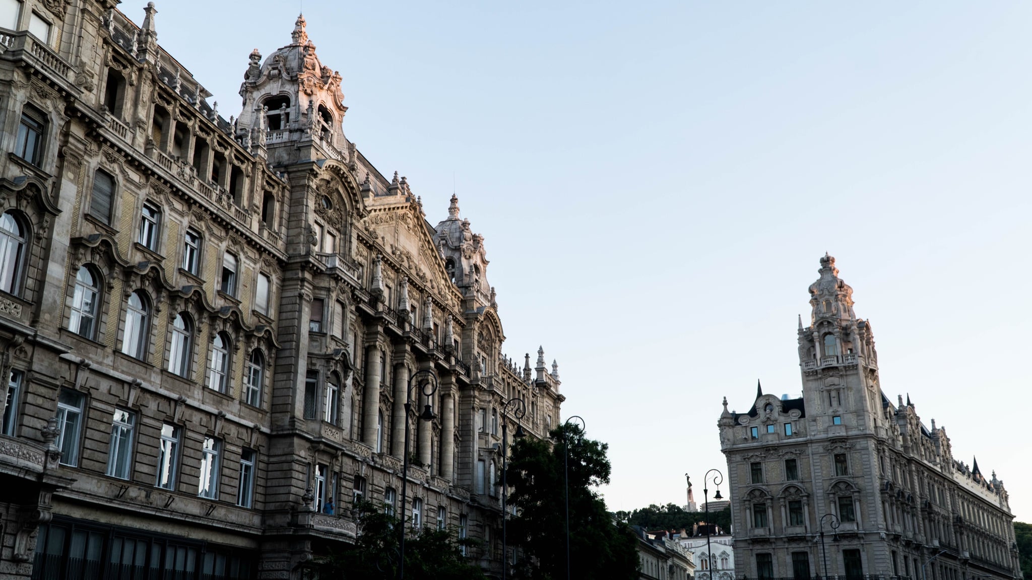 Eclectic rooftops and turrets of downtown Pest, the Liberty Statue on the distant hill