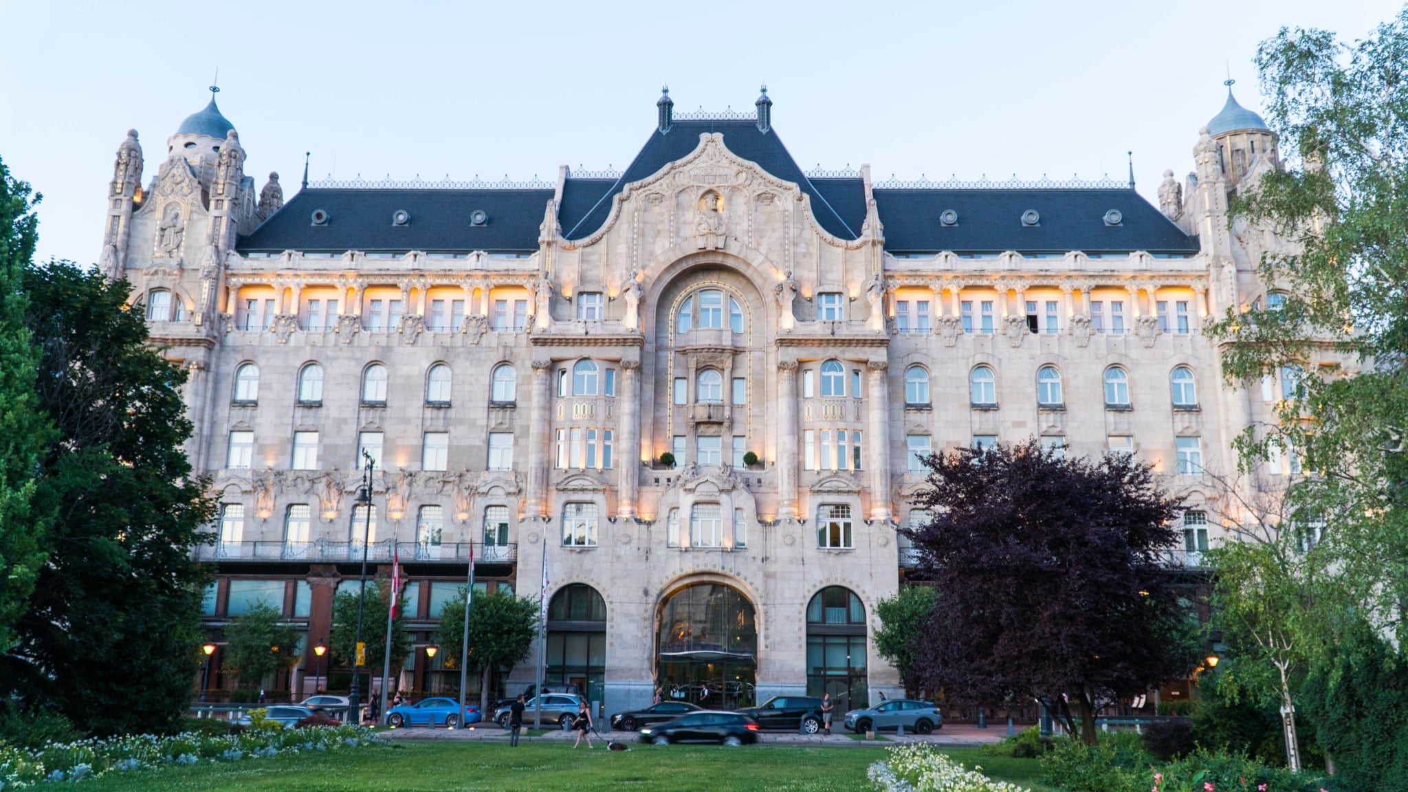 The Art Nouveau facade of the Gresham Palace glowing at dusk
