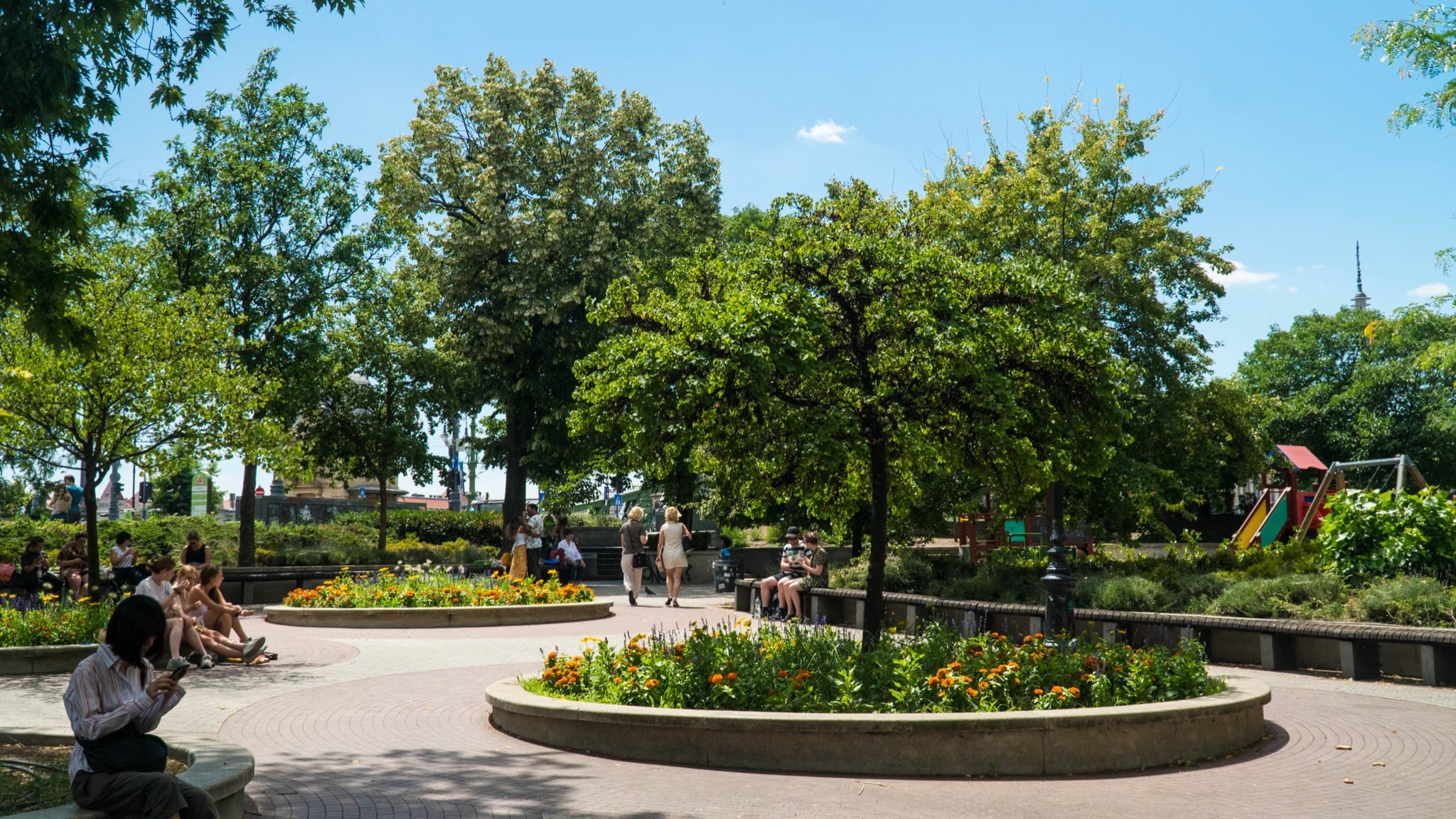 Circular flower beds and shade trees in a downtown pocket park