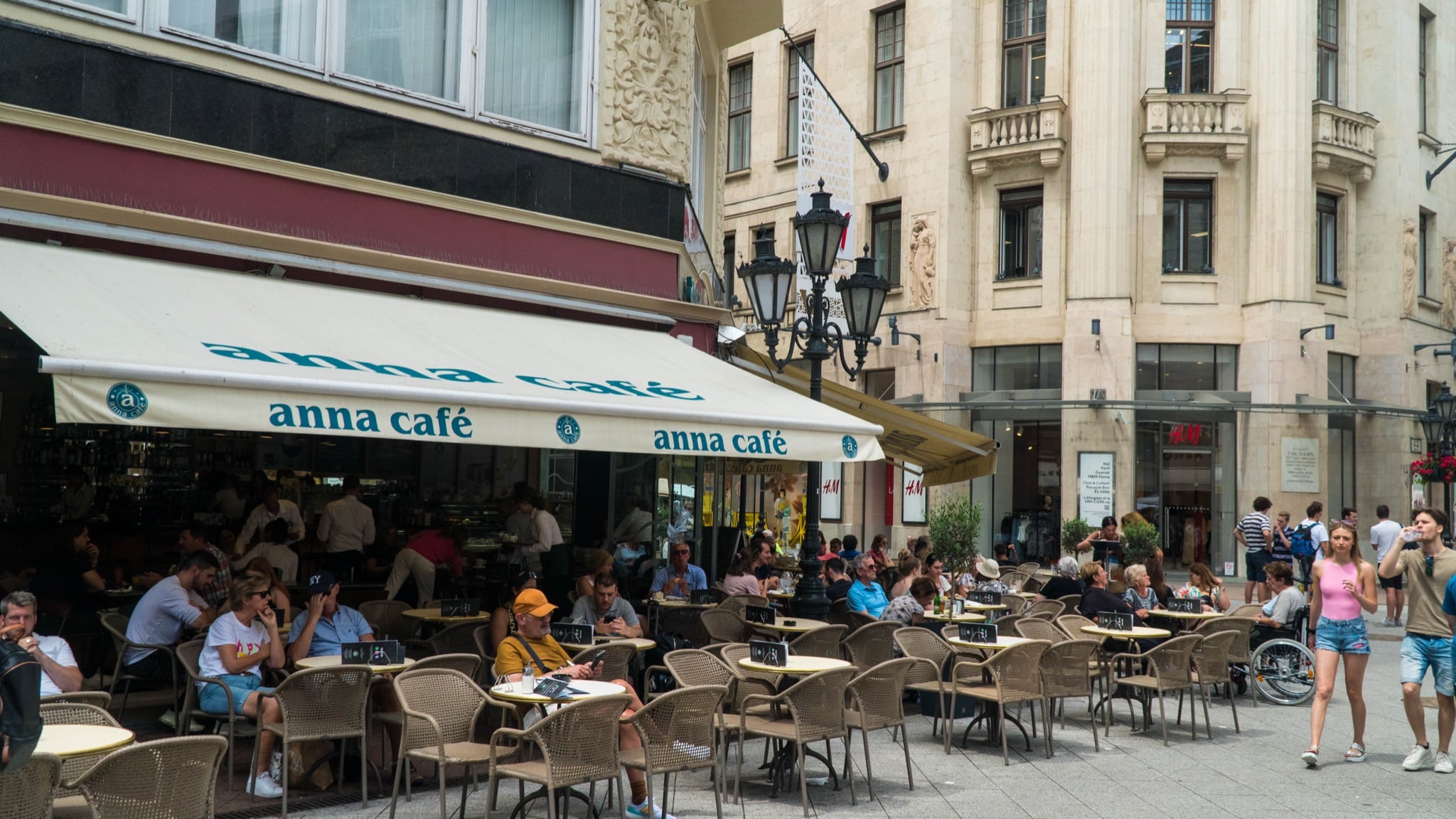 Café tables spilling across the pavement under the anna café awning