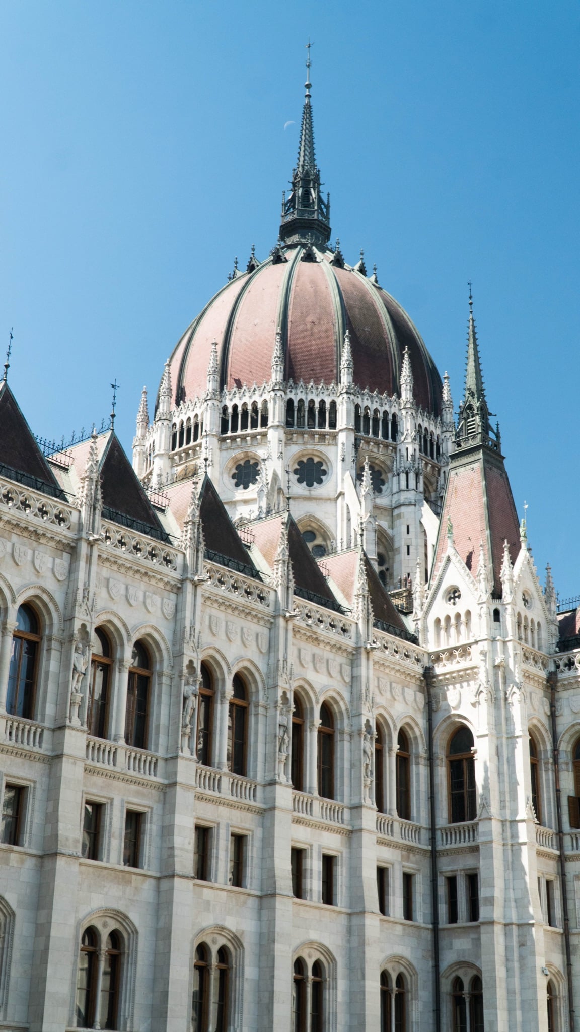 The Parliament's ribbed red dome and pinnacled tower against a clear sky