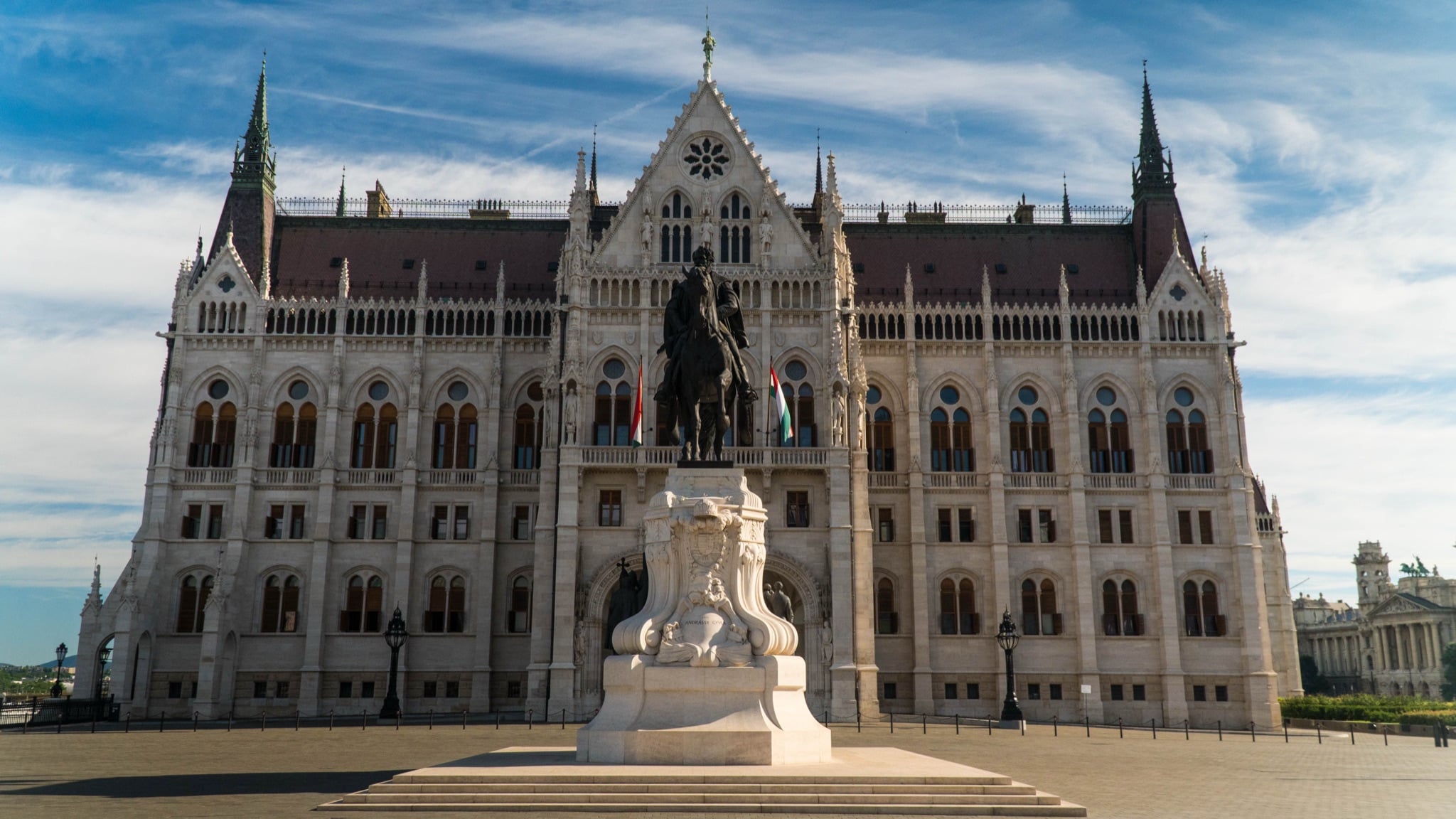 The symmetrical Danube facade of the Hungarian Parliament behind the equestrian statue of Gyula Andrássy