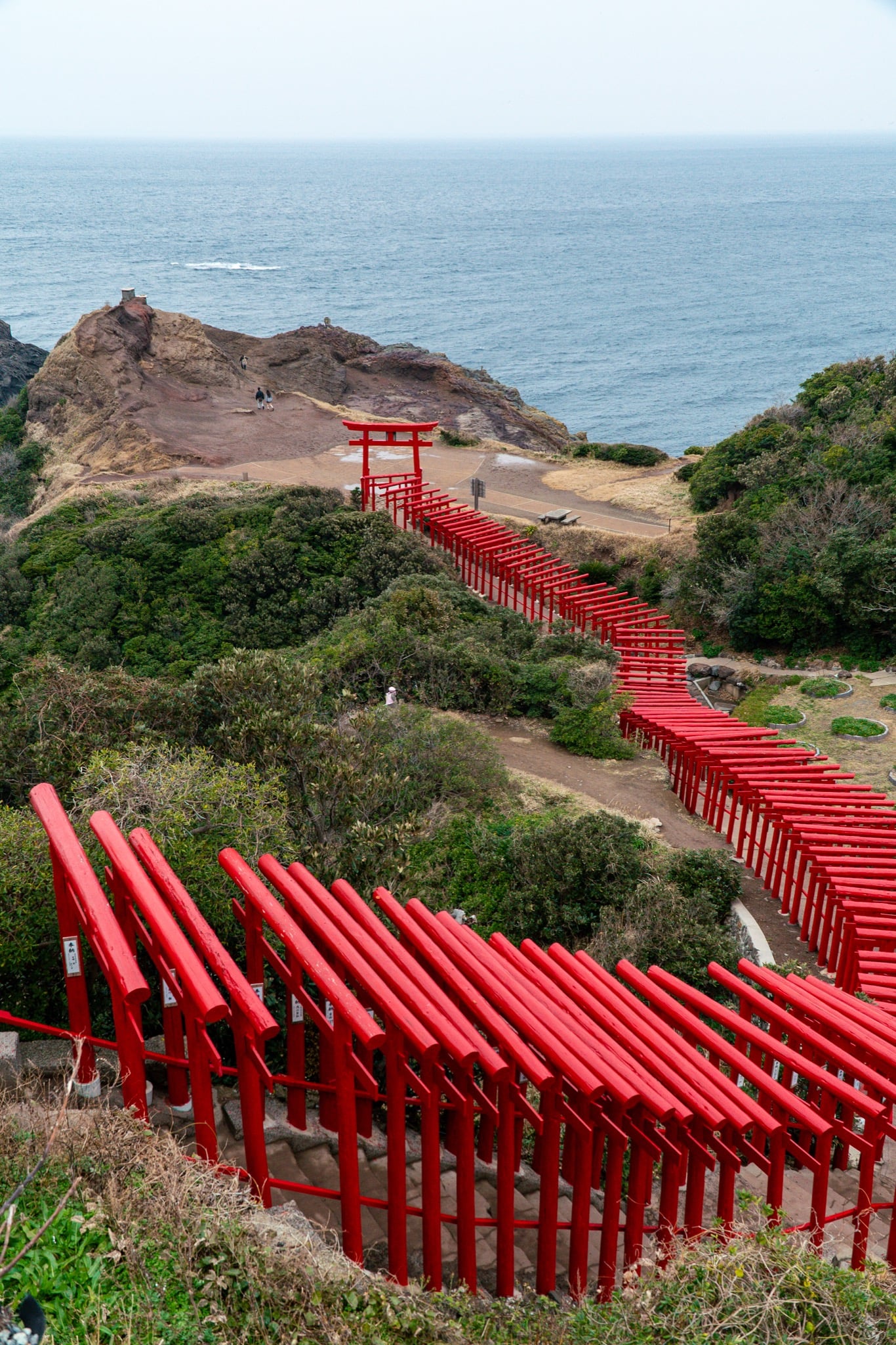 Red torii winding down the cliffs to the Sea of Japan at Motonosumi Inari