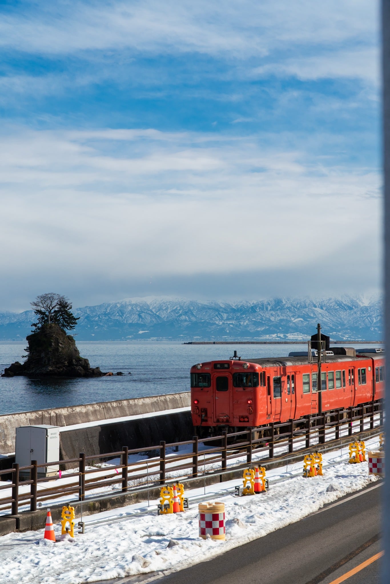 A local train running beneath the Tateyama mountains, Toyama