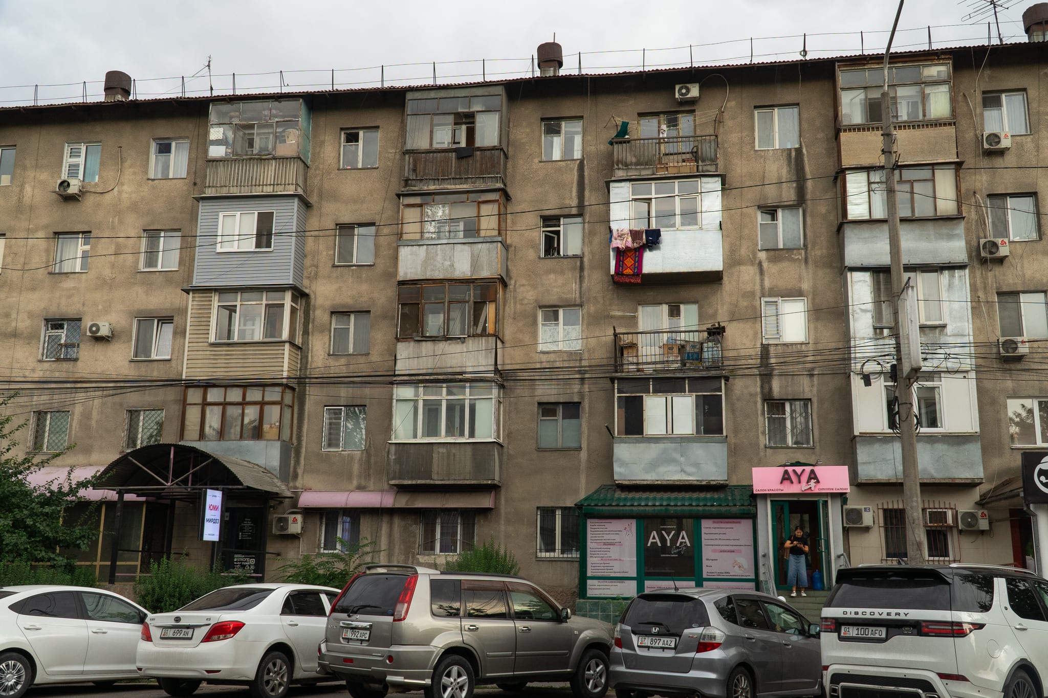 Soviet-era apartment blocks lining a Bishkek avenue
