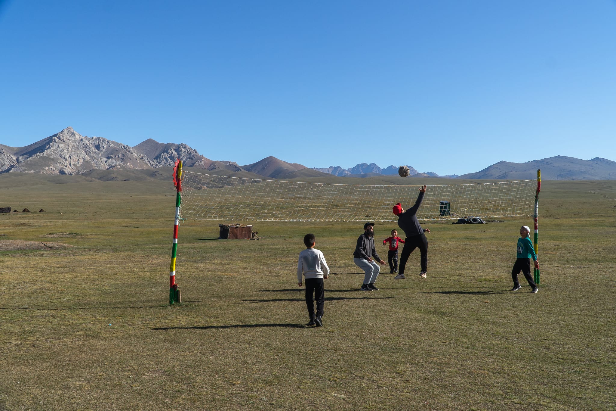 A herding family outside their yurt at Song-Kul