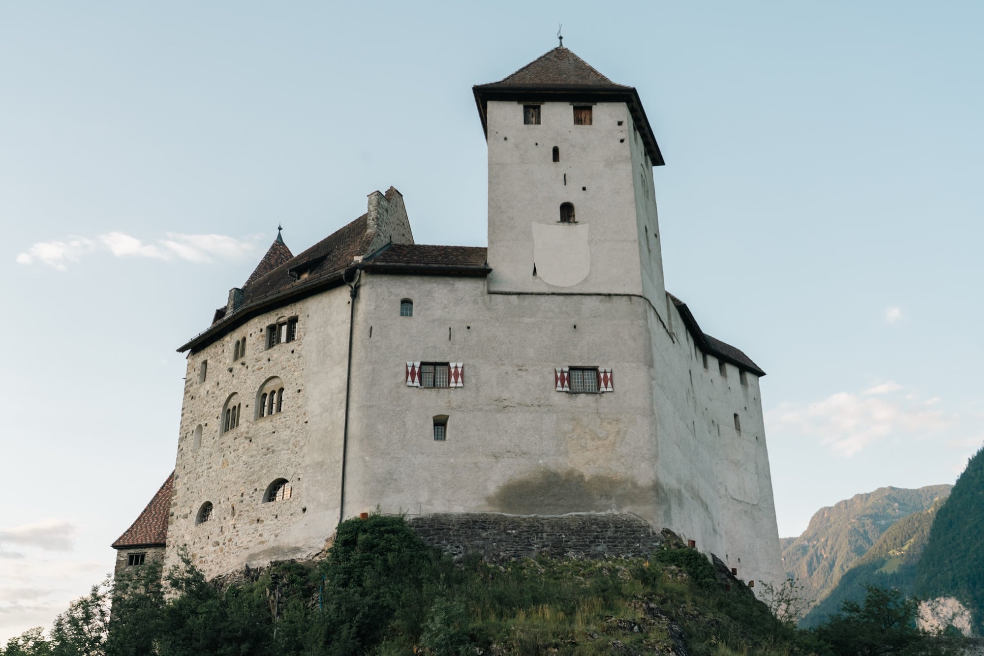 Gutenberg Castle, a whitewashed medieval keep with a square tower, on its rocky hill above Balzers