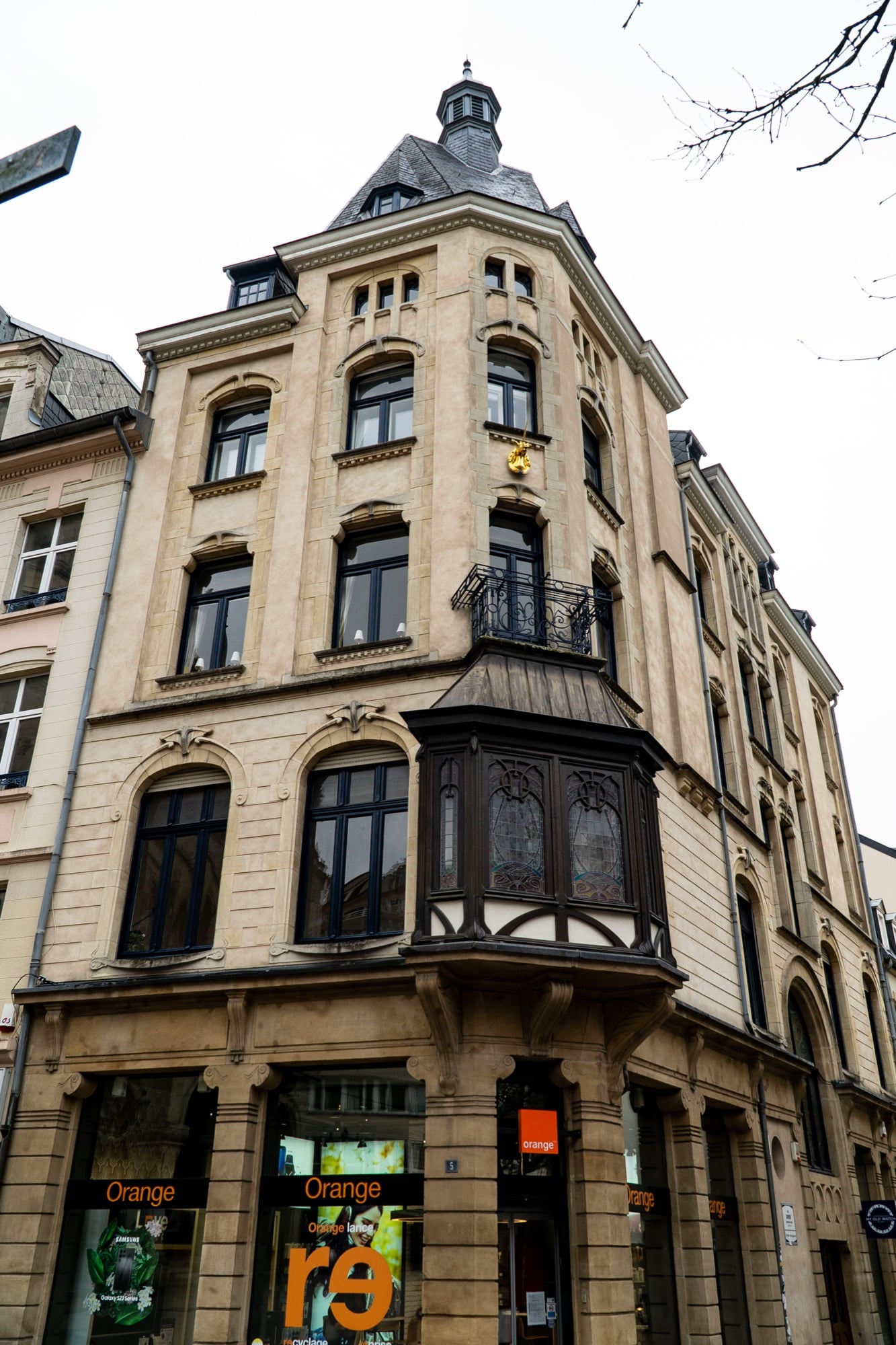 An Art Nouveau corner building with a turret and carved oriel window, Luxembourg City