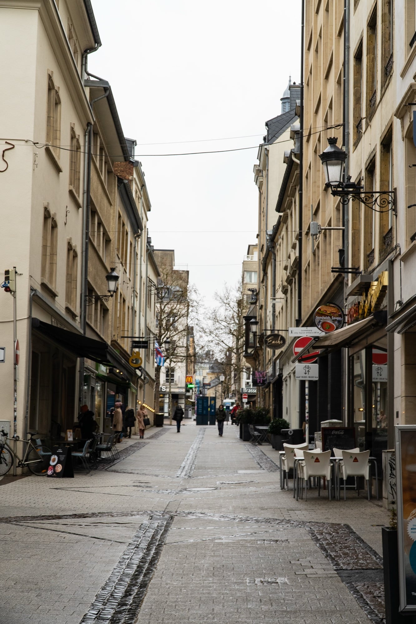 A pedestrian shopping street with cafés receding through the old town, Luxembourg City
