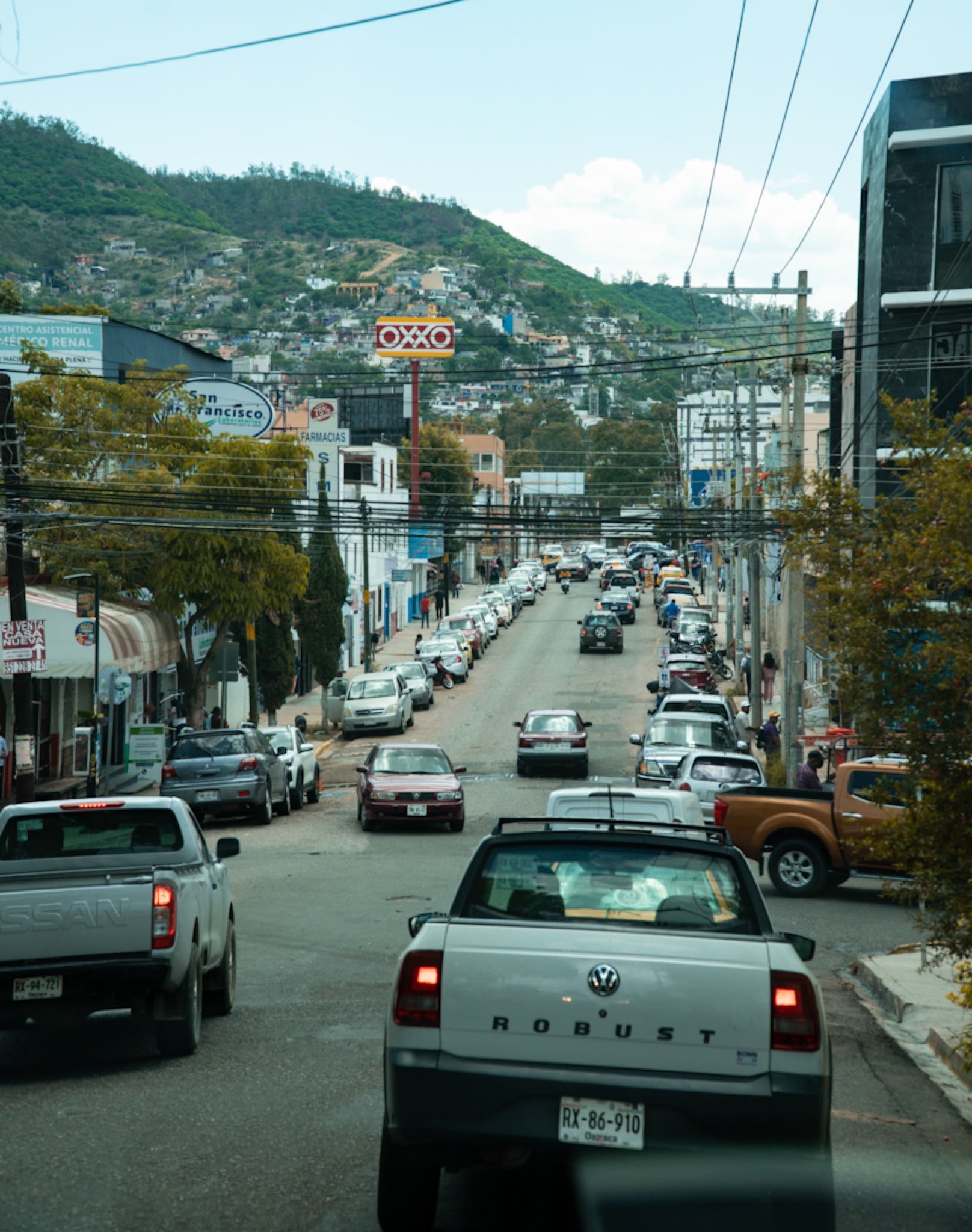 Cars climbing a street toward the hills above Oaxaca