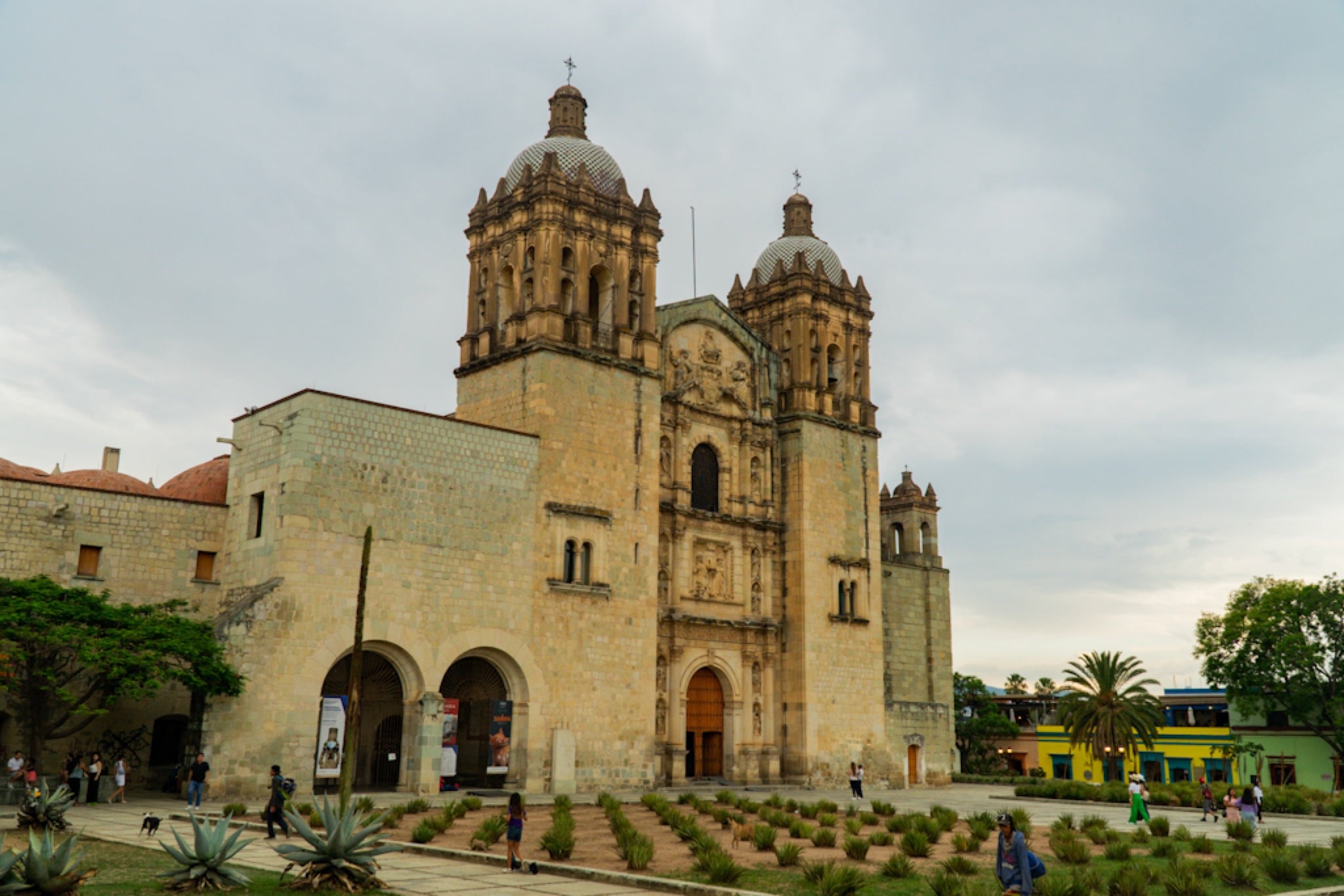 The stone facade of Santo Domingo de Guzmán beside its garden