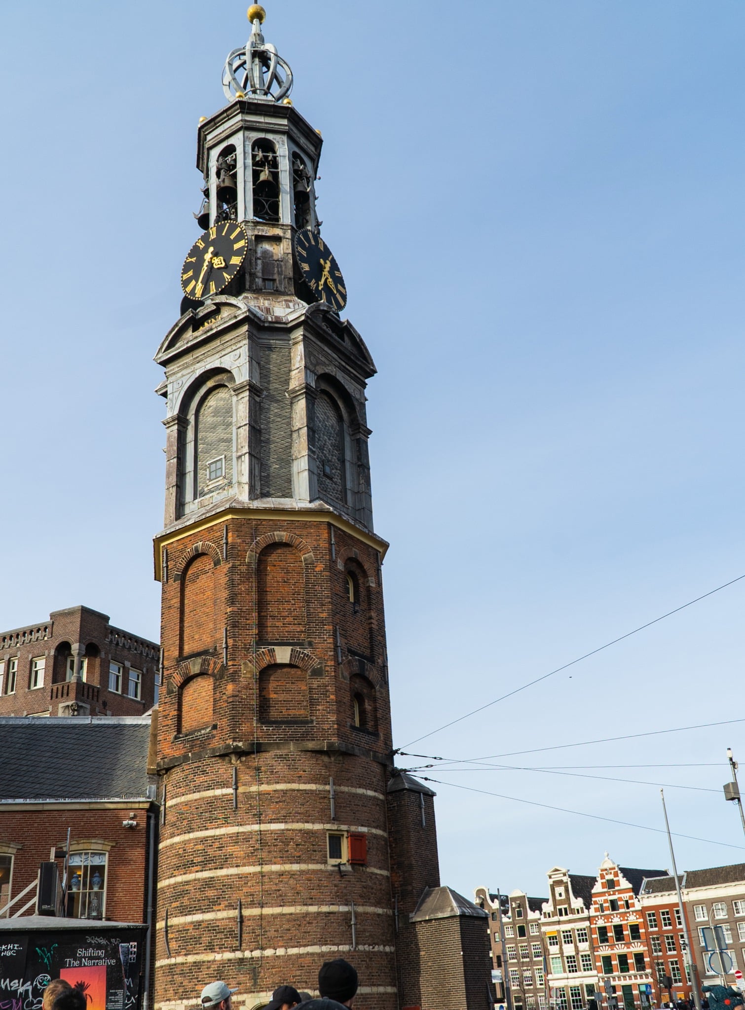 The Munttoren, the old Mint Tower, with its clock faces and carillon spire against a blue sky