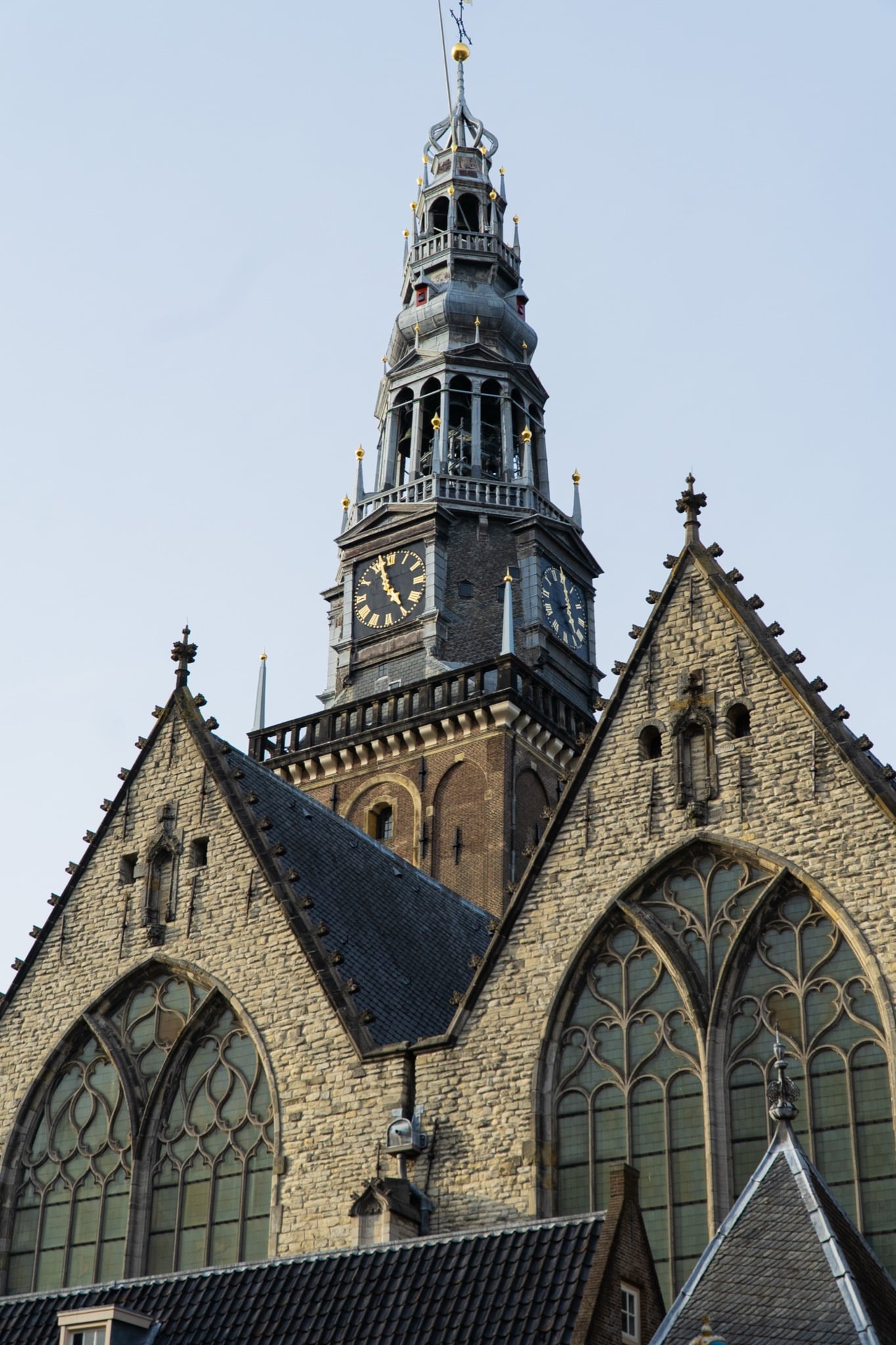 The Gothic tower and gabled roofs of the Oude Kerk with its twin gilded clock faces