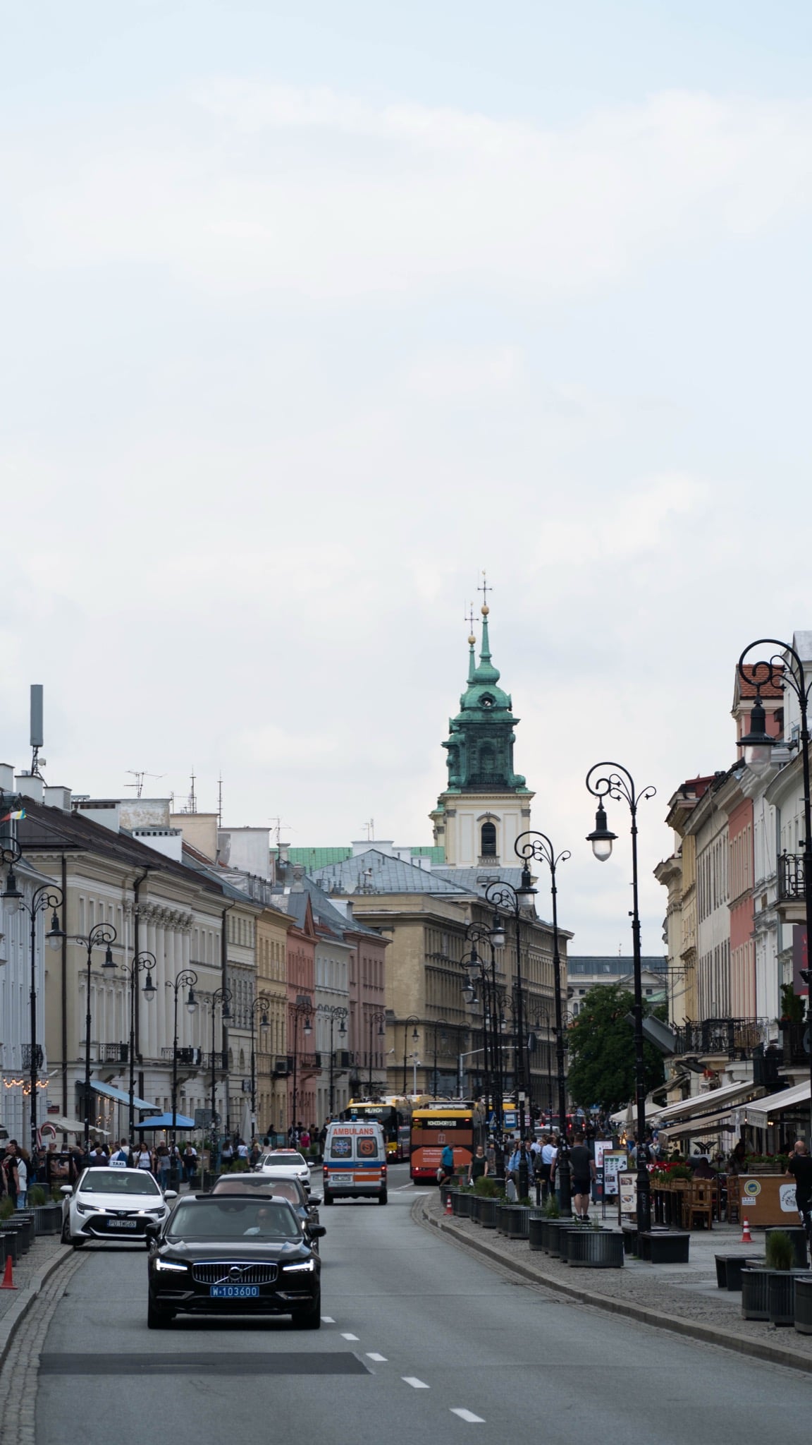A view down Krakowskie Przedmieście toward the green-domed tower of Holy Cross Church