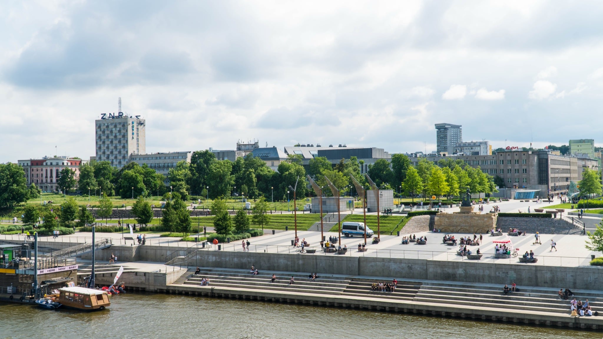 The terraced Vistula Boulevards riverfront, a canal boat moored below the ZNP tower