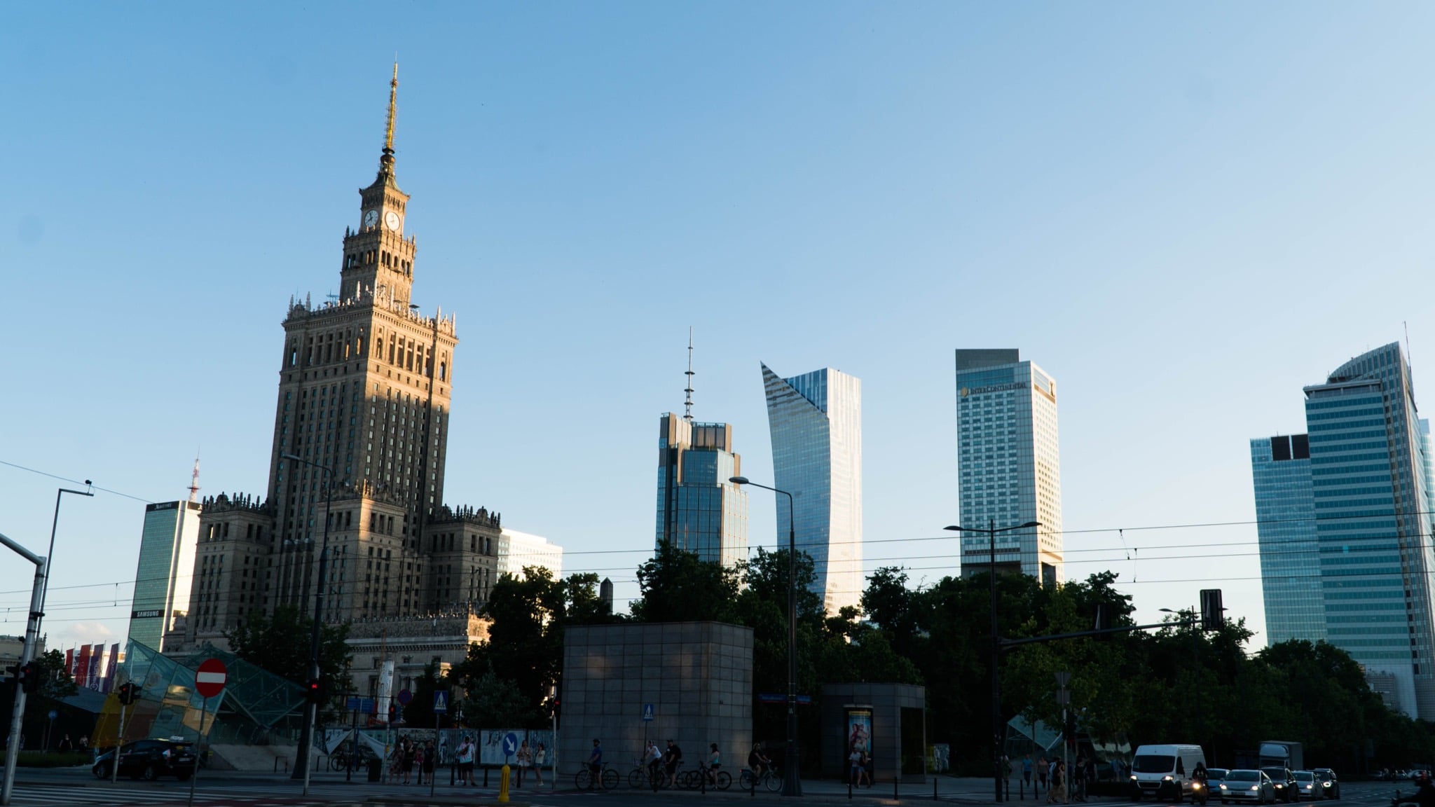 The Warsaw skyline at golden hour, the Palace of Culture and Science among glass skyscrapers