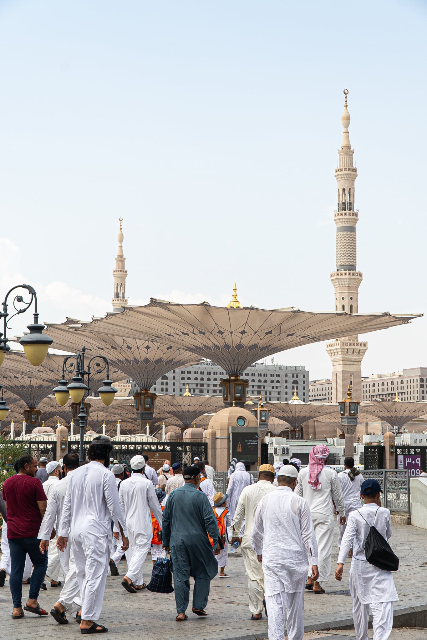 Pilgrims crossing the plaza of the Prophet's Mosque