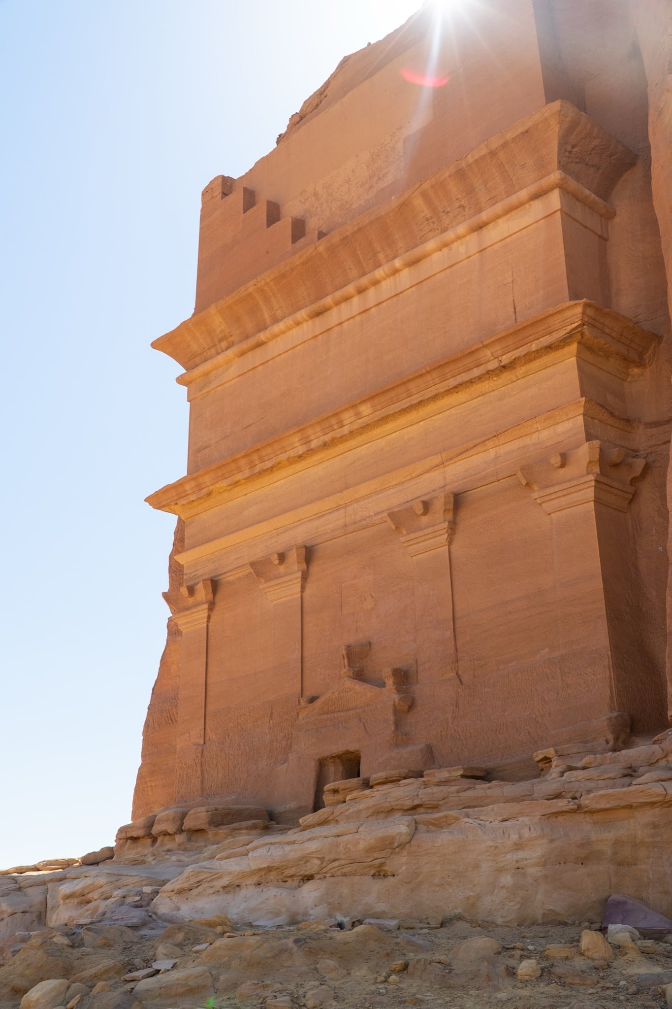 A monumental Nabataean tomb carved into the orange sandstone at Hegra