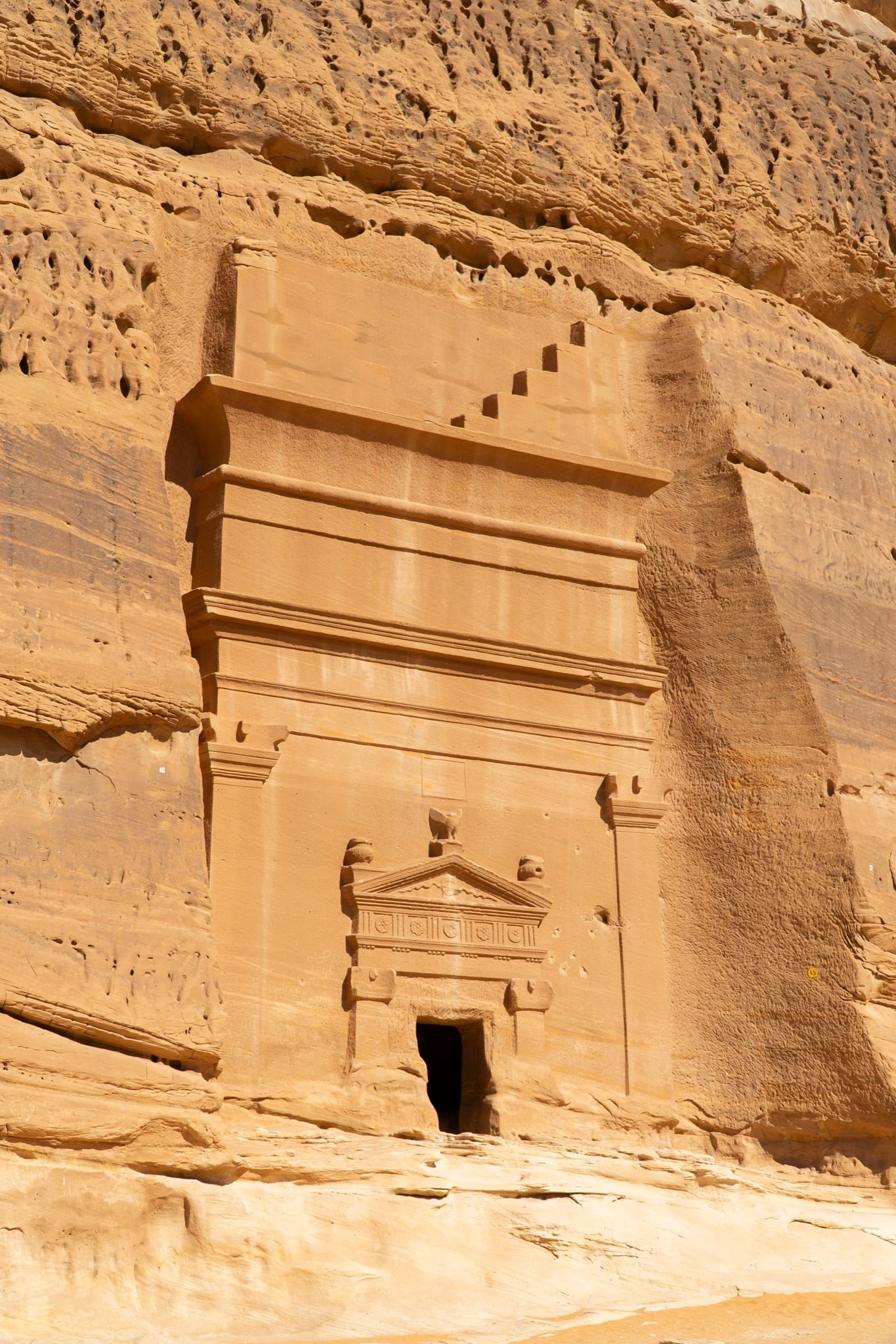 Detail of a weathered Nabataean facade at Hegra